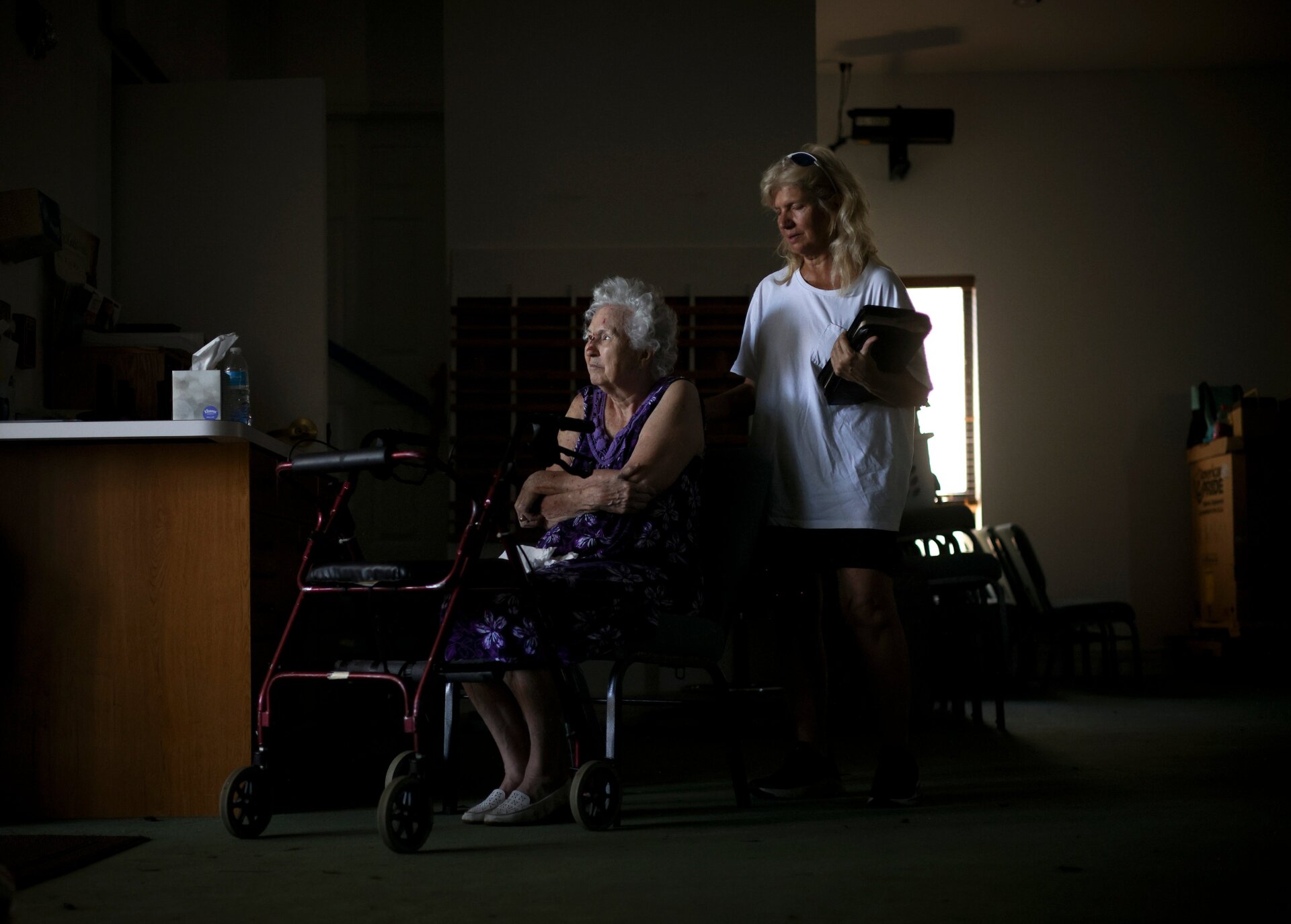 Charlene Flener, pictured seated in a wheelchair, in Southwest Baptist Church on Sunday, October 2; Fiener’s home was damaged during the hurricane and she is staying at the church temporarily.