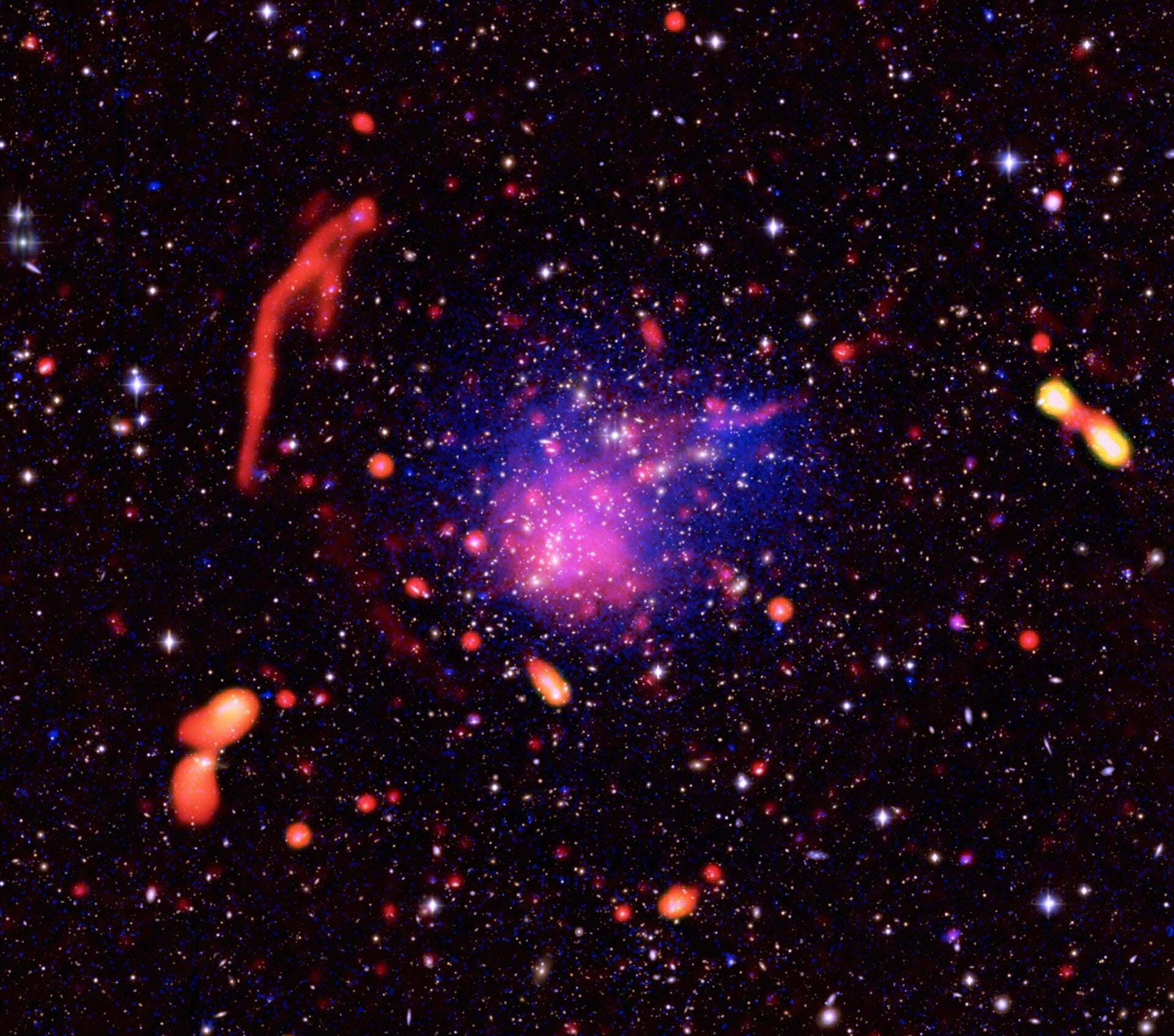 A composite image of Abell 2744, seen by Chandra, Subaru, and the Jansky Very Large Array. Lensing: NASA/STScI, NAOJ/Subaru, ESO/VLT; Optical: NASA/STScI/R.Dupke