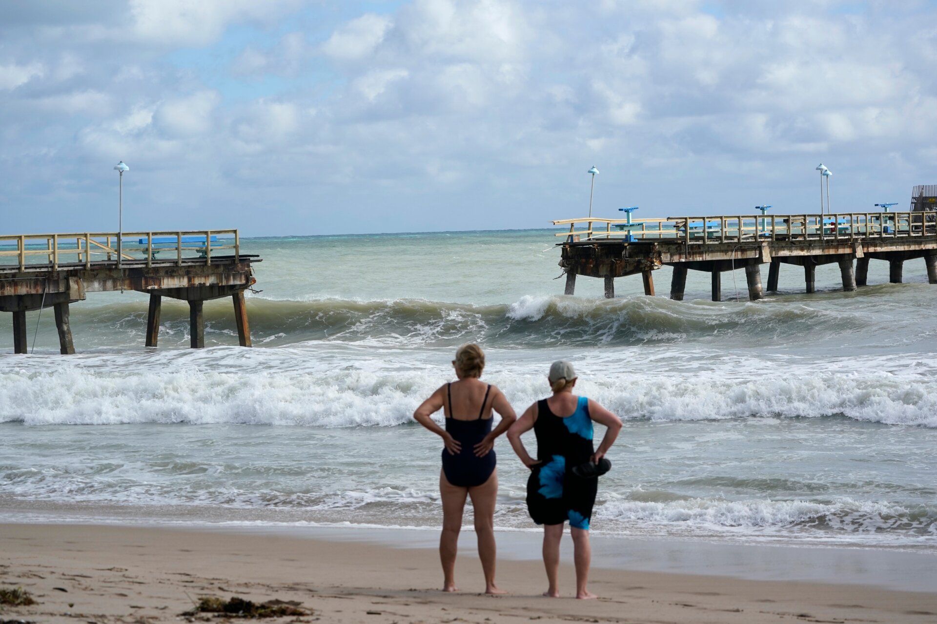 Beach goers surveyed the damage following the storm. Sections of Anglin’s Fishing Pier in Luaderdale-by-the-Sea collapsed into the waves.