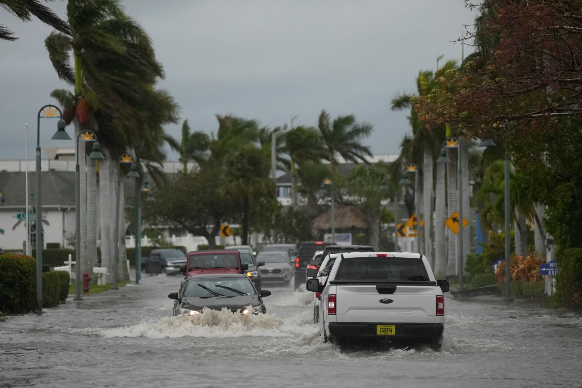 Drivers navigate a flooded road during Hurricane Nicole in Fort Pierce, Florida.