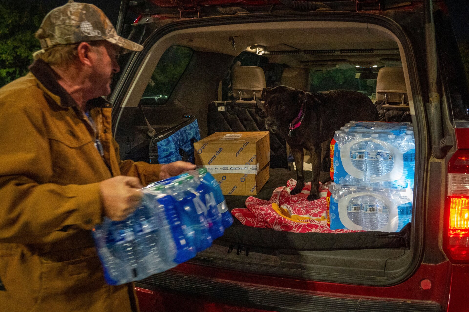 John Beezley, of Bonham, loads several cases of water after learning  that a boil water notice was issued for the entire city of Houston on  Sunday, Nov. 27, 2022, at Walmart on S. Post Oak Road in Houston.