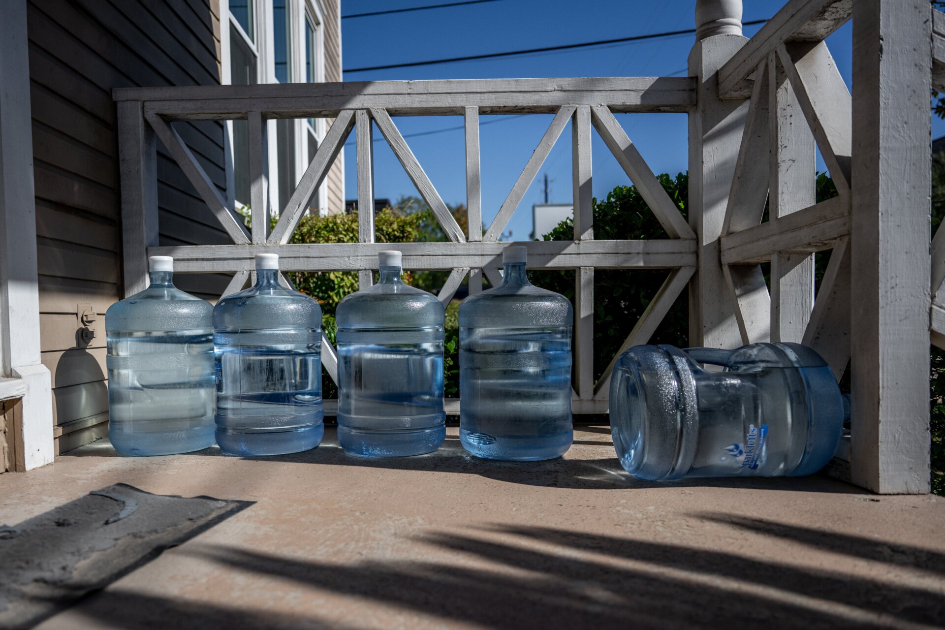 Filled water jugs are seen on a porch on November 28, 2022 in Houston, Texas.