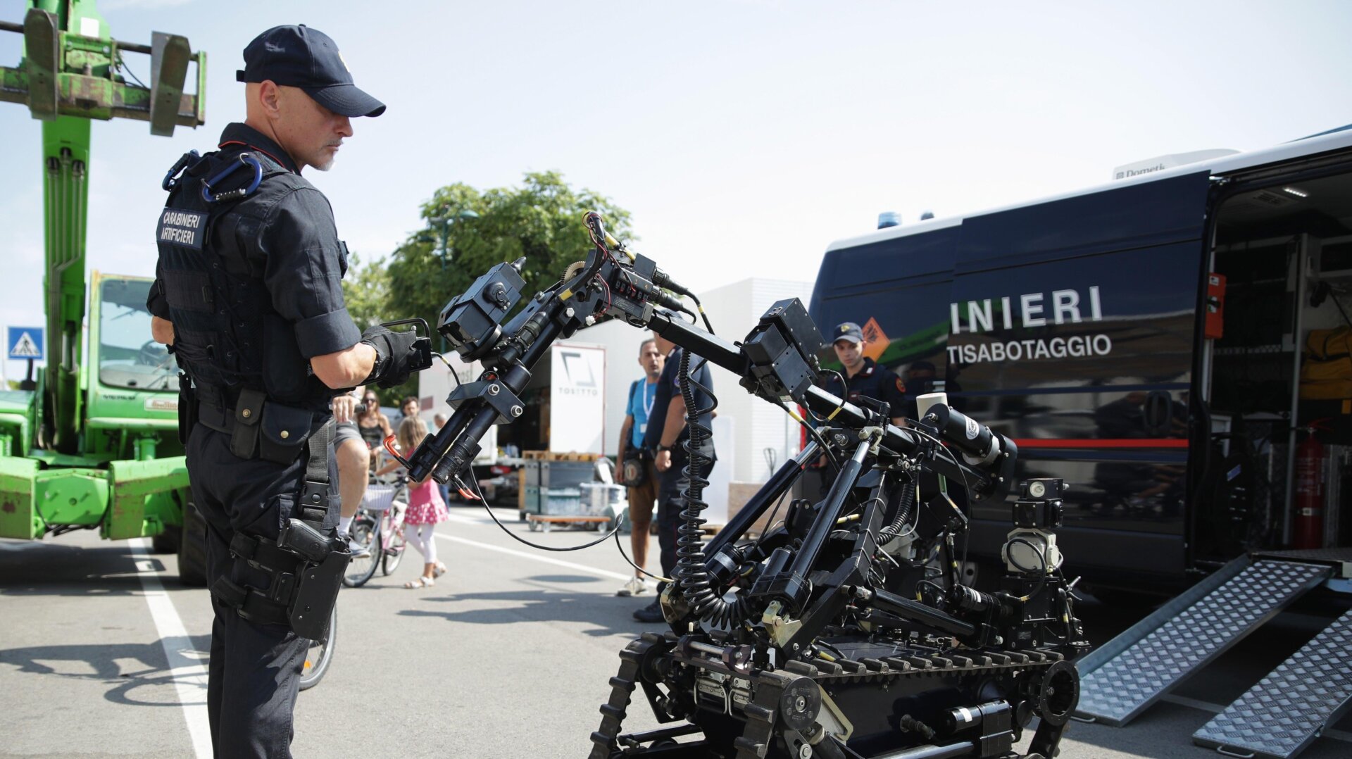 A police officer carries out a demonstration with a bomb disposal robot.