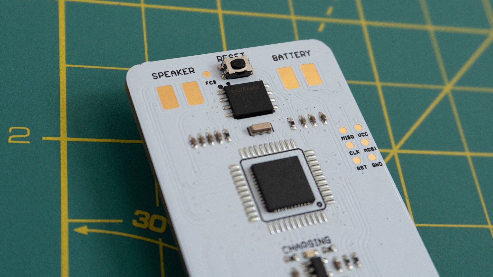 The back of the Arduboy Mini features exposed contacts for attached a rechargeable battery and a speaker.