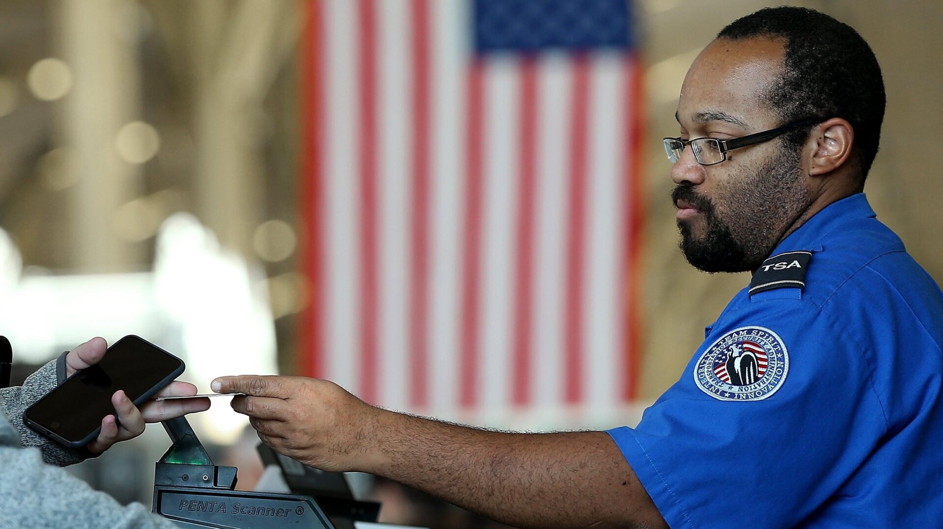 An officer from the Transportation Security Administration checks travel documents for passengers 