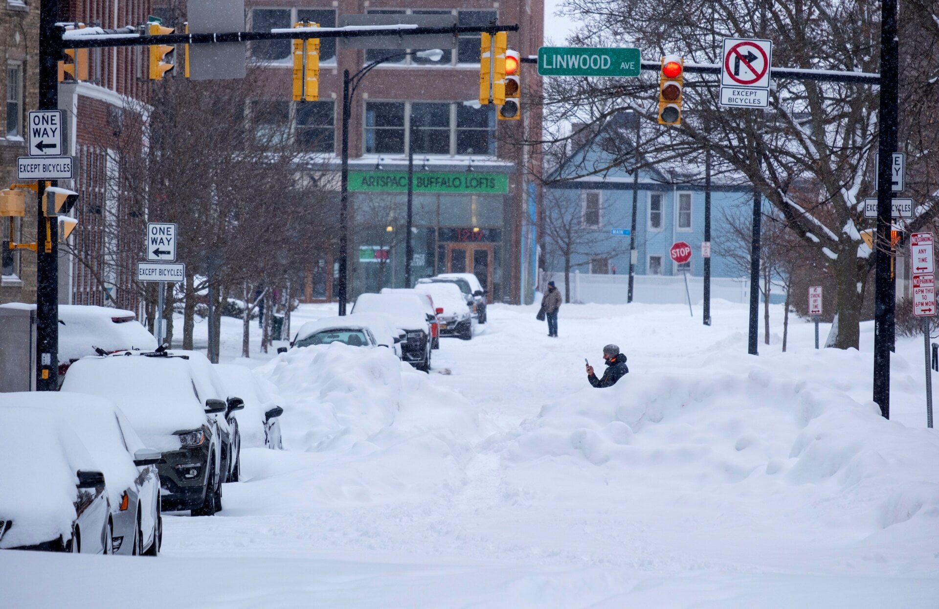 People move about the streets of the Elmwood Village neighborhood of Buffalo, N.Y. Monday, Dec. 26, 2022, after a massive snow storm blanketed the city.