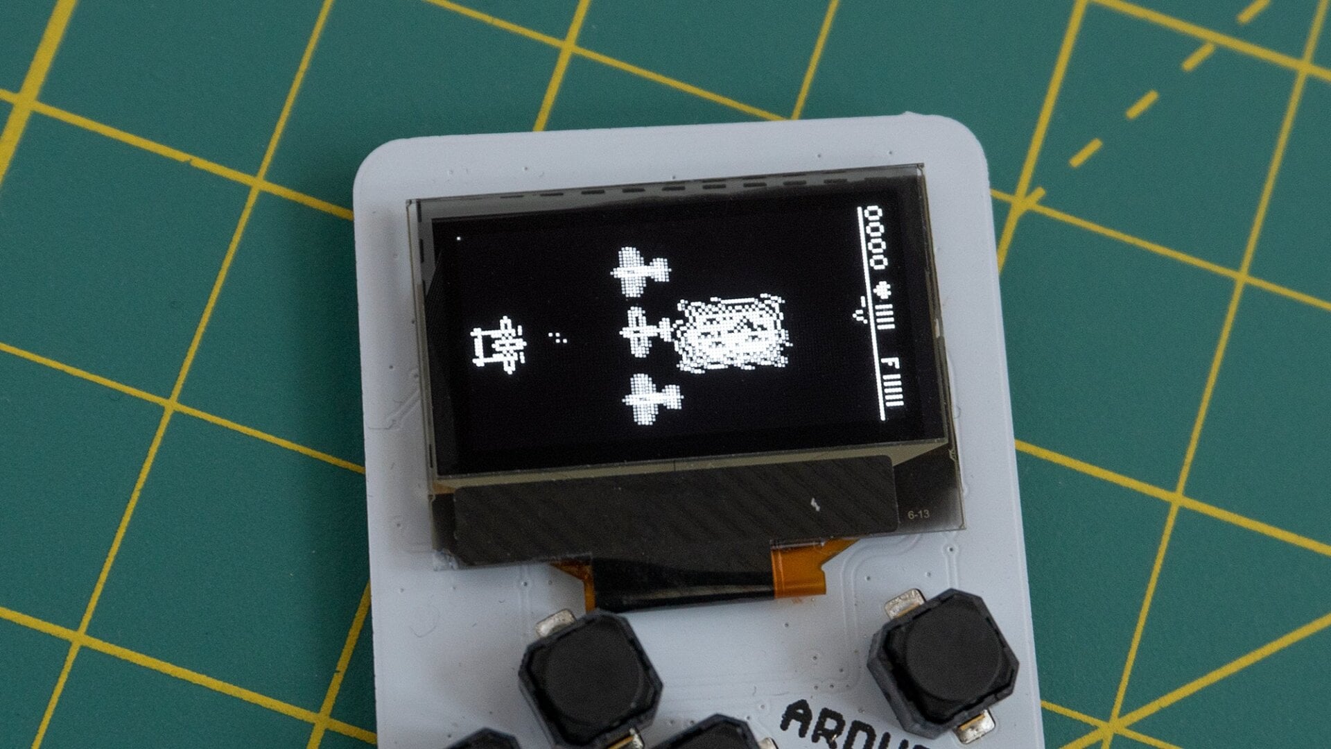 The Arduboy Mini uses a monochromatic OLED screen which can only display black and white images—no grayscale.