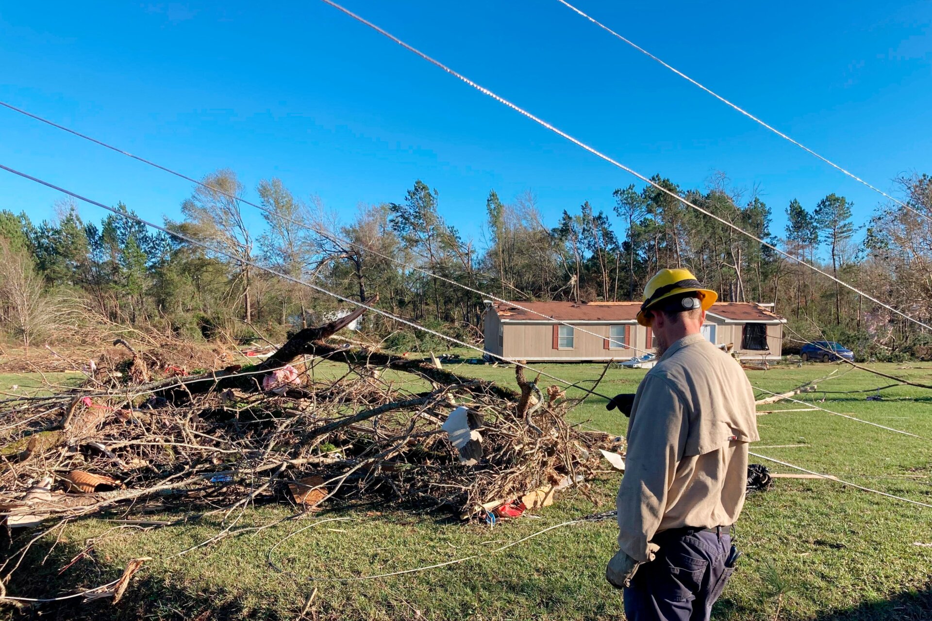 A utility worker observes damage in Keithville, Louisiana. 