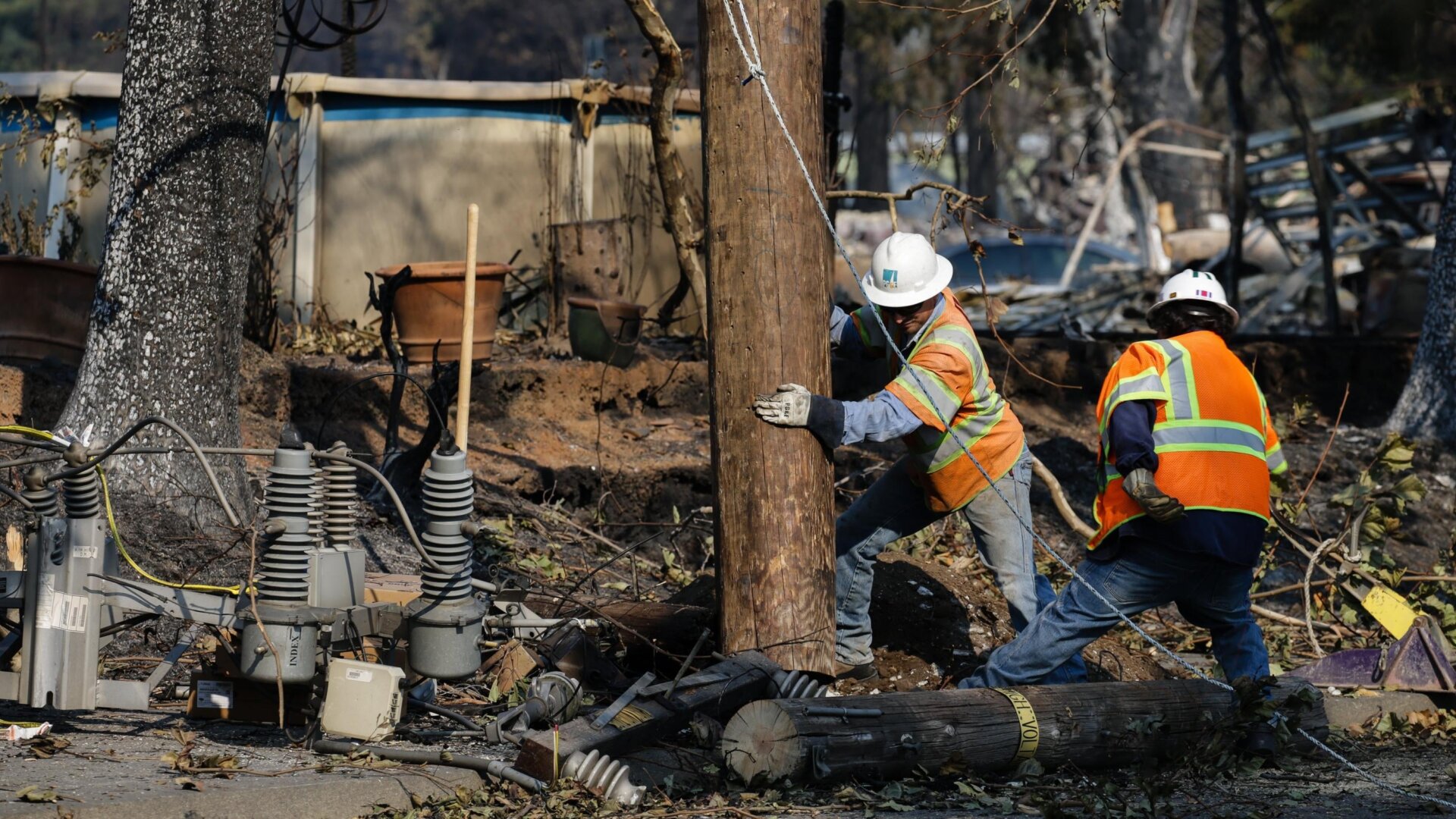 PG&E workers repair power lines in the Coffey Park neighborhood following the damage caused by the Tubbs Fire on October 13, 2017 in Santa Rosa, California.