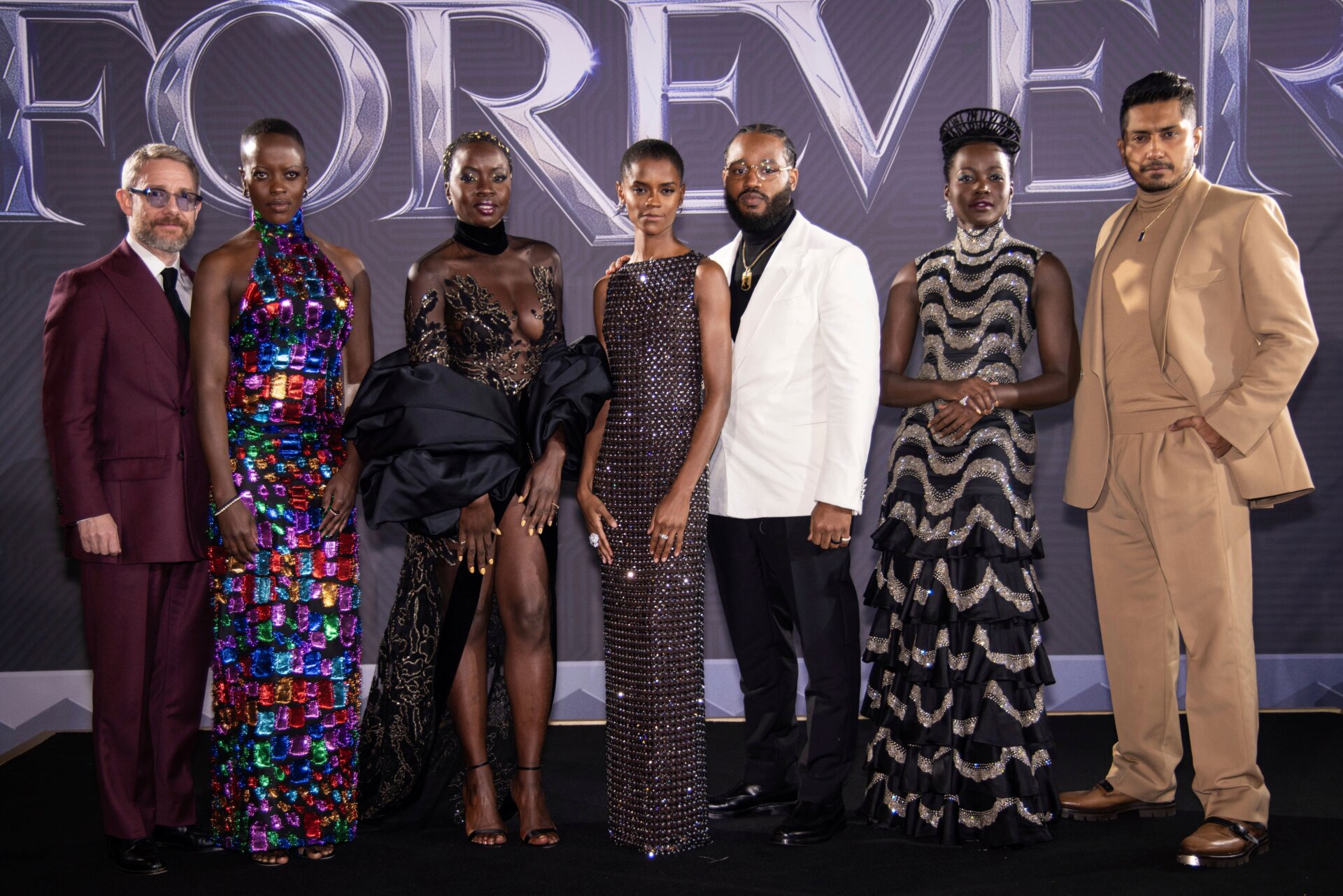 Martin Freeman, Florence Kasumba, Danai Gurira, Letitia Wright, Ryan Coogler, Lupita Nyong’o, and Tenoch Huerta pose at the premiere of Black Panther: Wakanda Forever in London.
