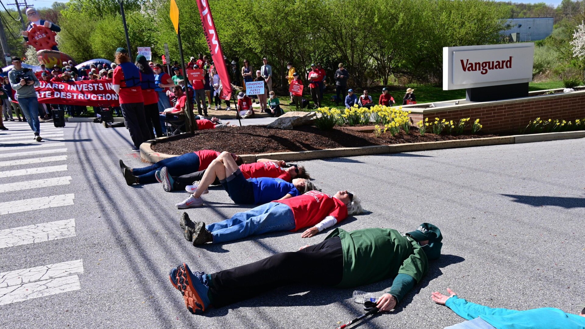 People lay down on the ground during the Vanguard SOS Campaign Fight For Our Future: Rally For Climate, Care, Jobs & Justice on April 22, 2022 in Malvern, Pennsylvania.