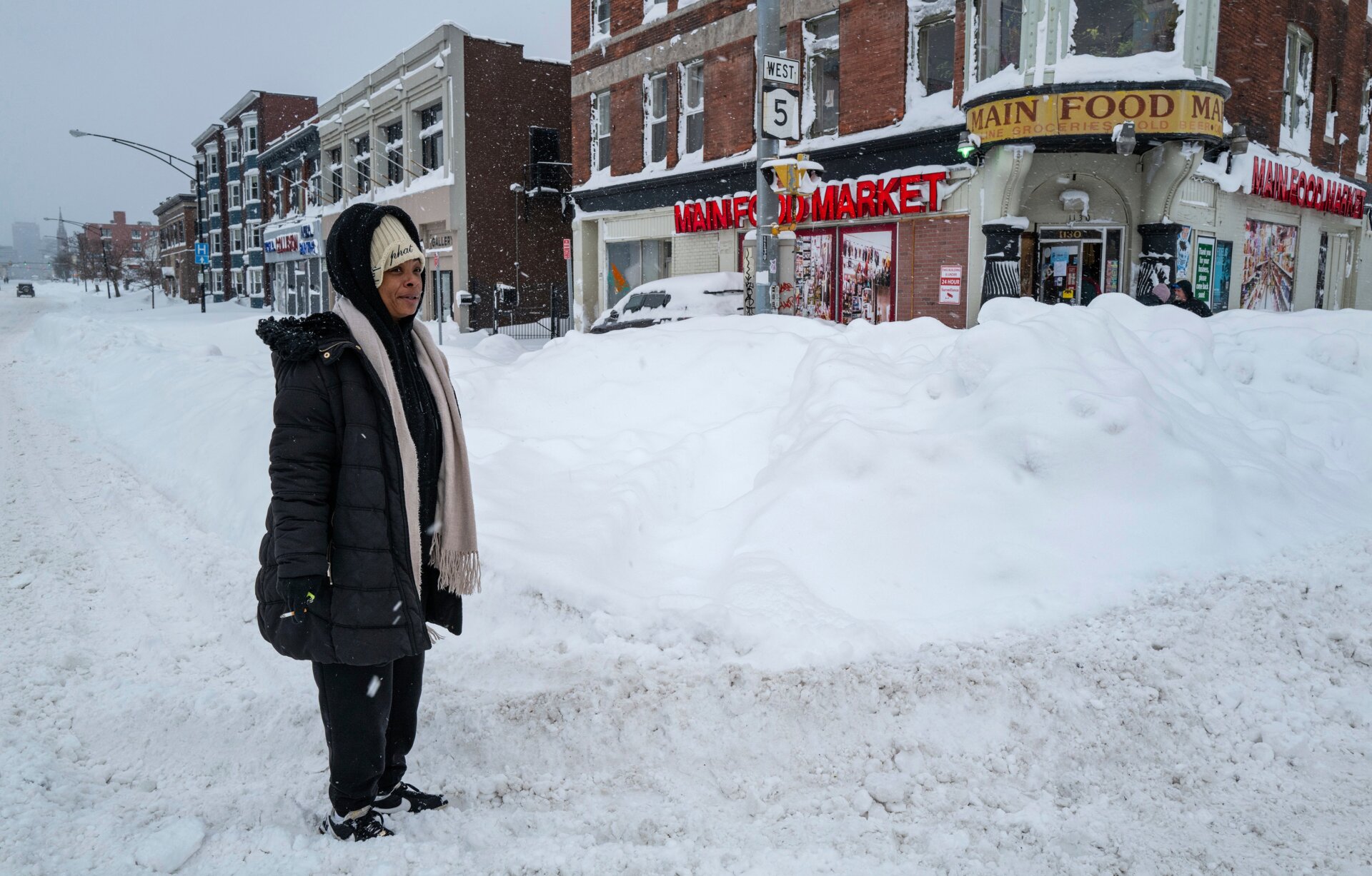 Kala Smith of Buffalo, N.Y., heads for a food store on Main St., not far from where she lives Monday, Dec. 26, 2022, after a massive snow storm blanketed the city. 