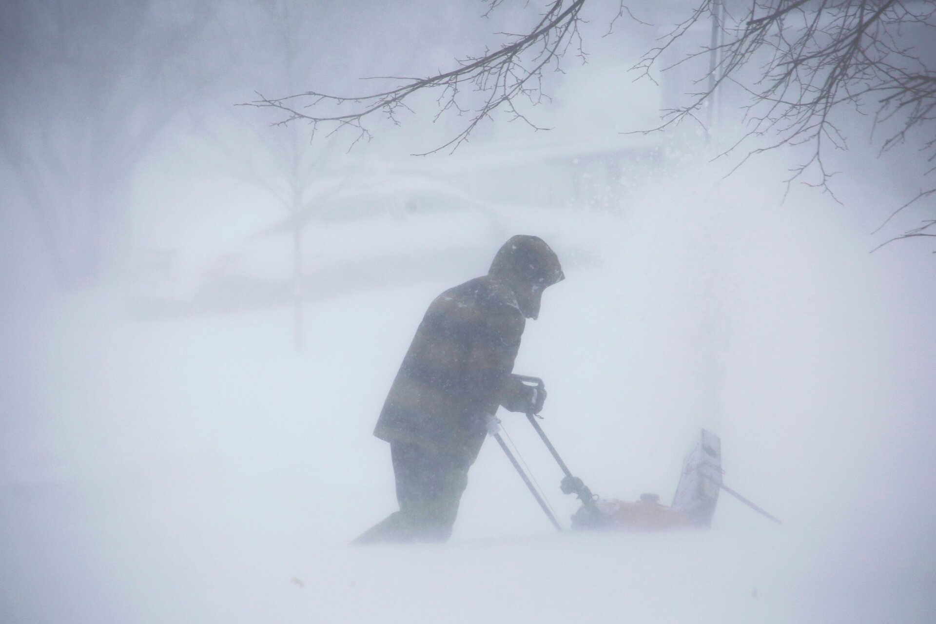 A person clears snow as a winter storm rolls through Western New York Saturday, Dec. 24, 2022, in Amherst N.Y.