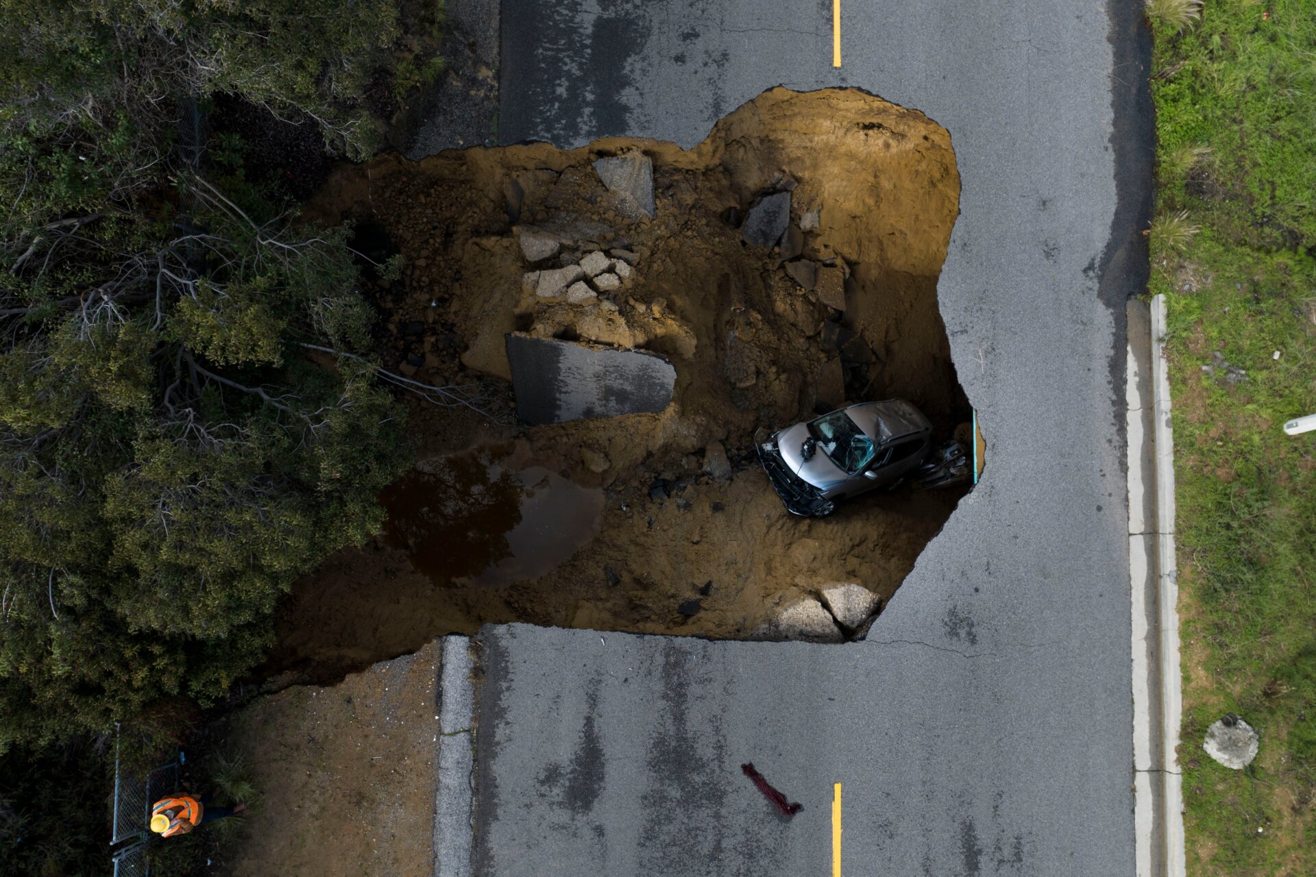 A car in a sinkhole in Los Angeles on Tuesday, January 10.