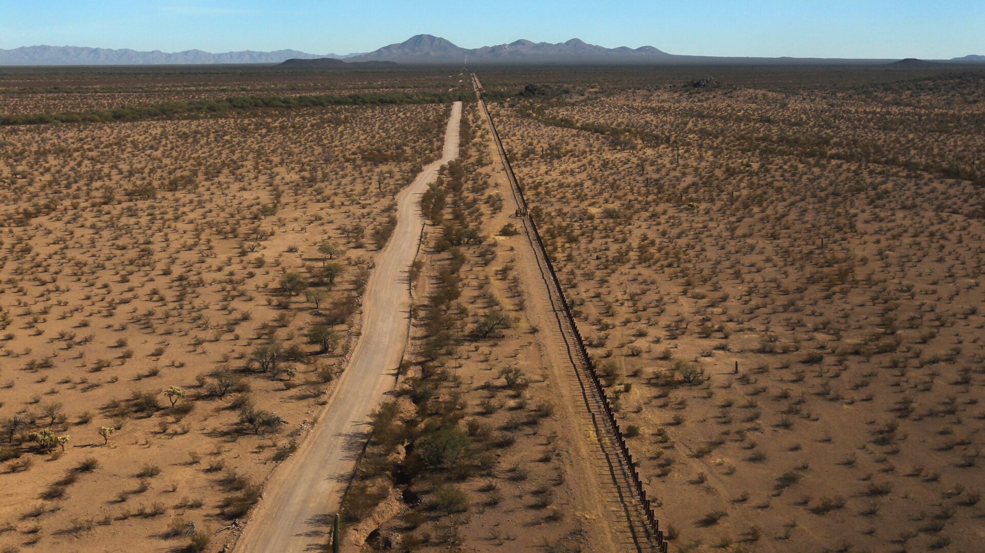As seen from the air, the U.S.-Mexico border fence (U.S.-L) stretches through the Sonoran Desert on December 9, 2010 in the Tohono O’odham Reservation, Arizona.