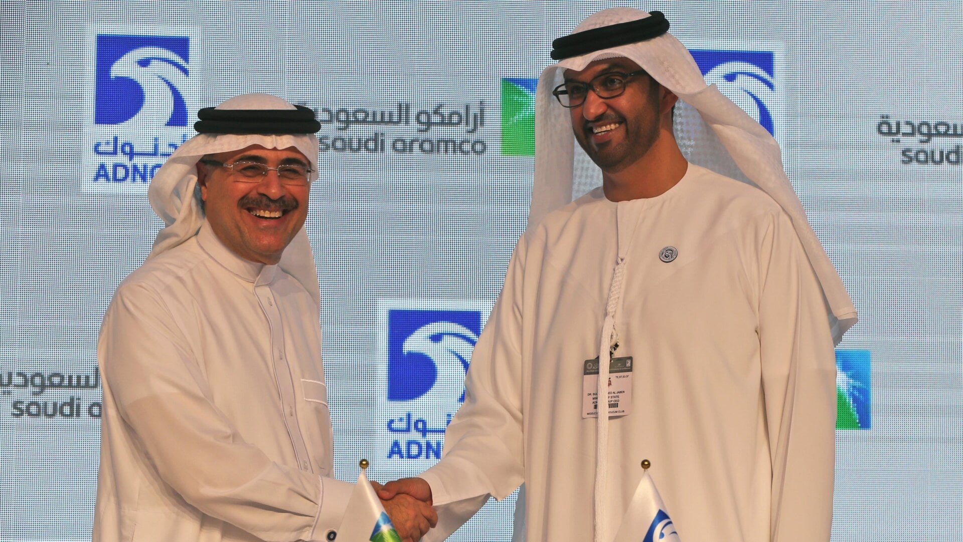 Saudi Aramco President, Amin Al-Nasser (left), shakes hands with Sultan Ahmed Al Jaber (right), ADNOC CEO, in 2018. Smiles brought to you by petroleum power.