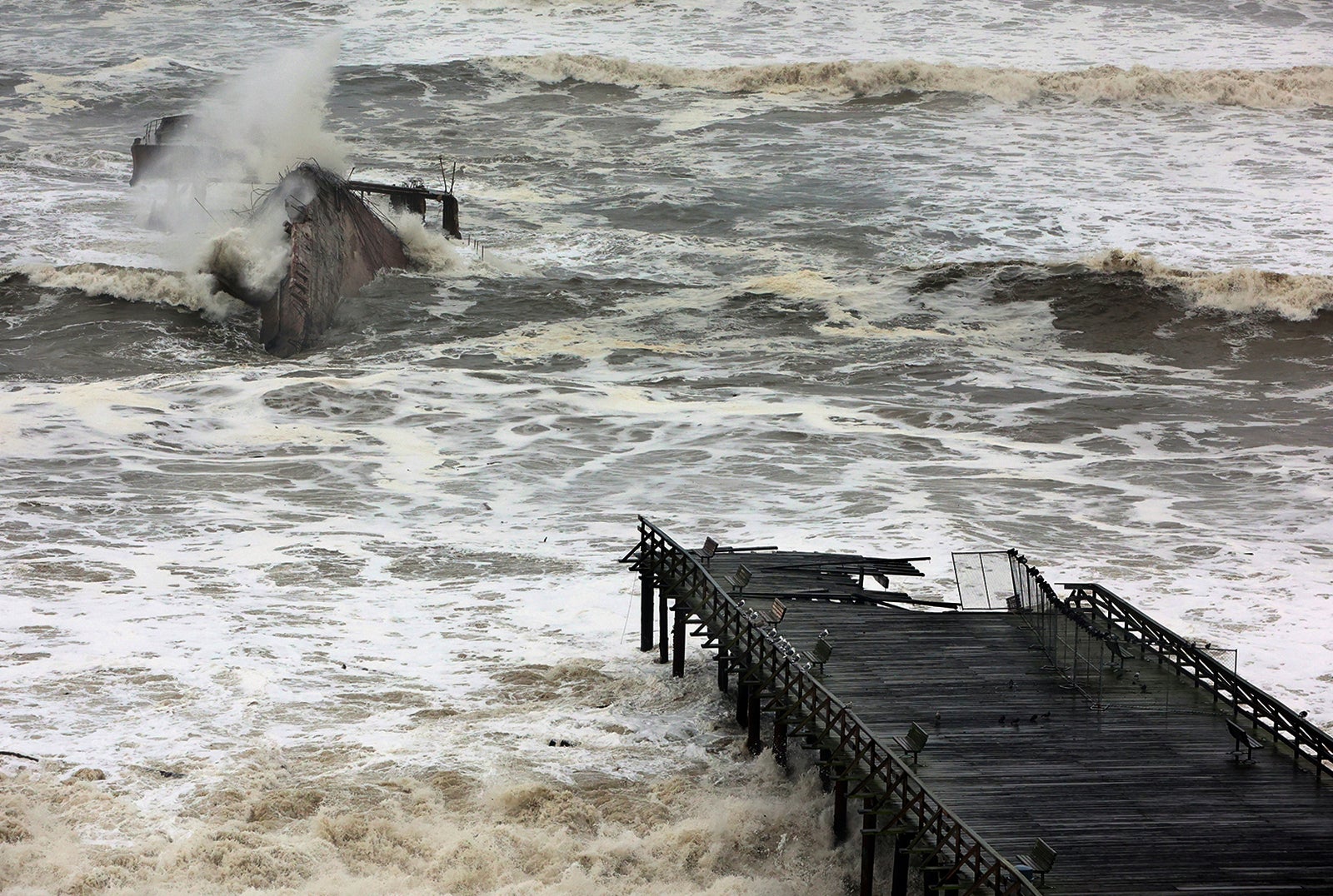 Powerful storm waves roll into Seacliff State Beach between the Cement Ship and the heavily damaged pier on Thursday, Jan. 5, 2023, in Capitola, California.