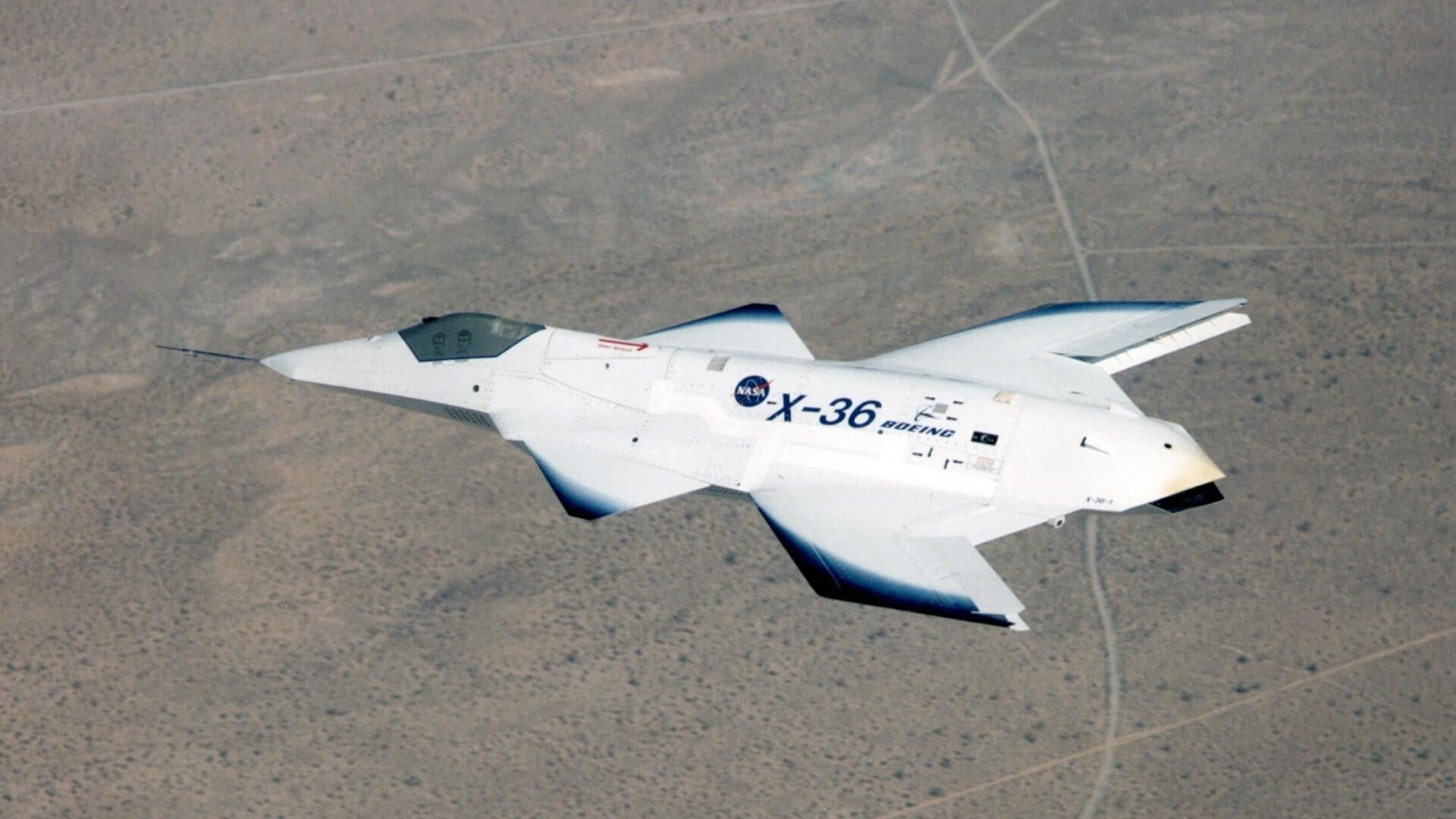 The tailless X-36 in flight over California in 1997. Note the illustrated people in the cockpit.