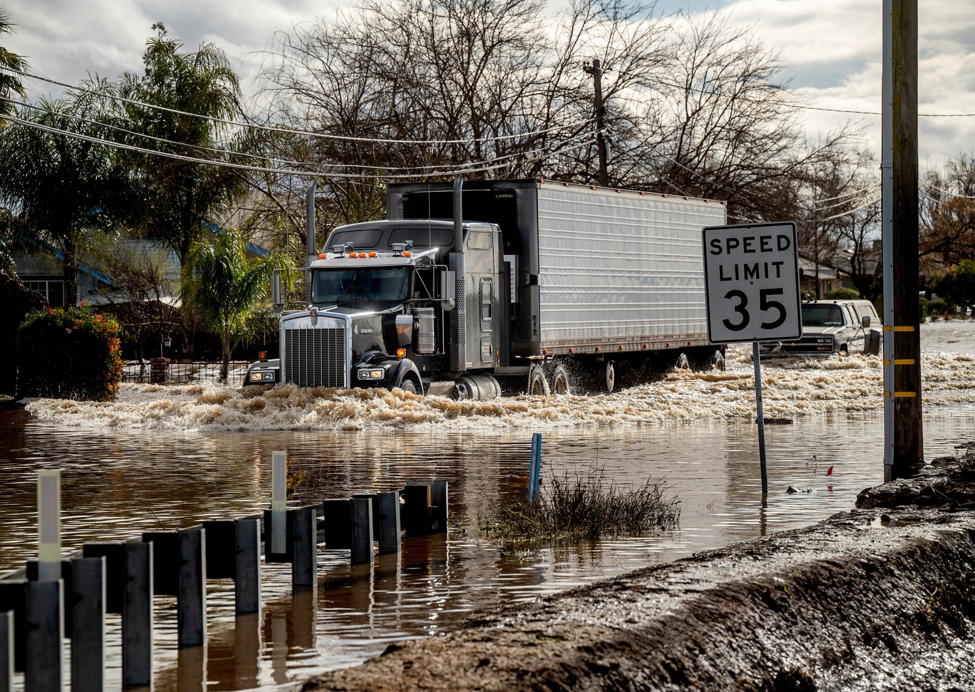 A truck drives through floodwaters in Merced.