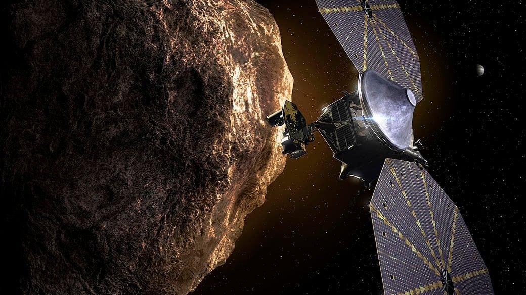 An illustration of the Lucy spacecraft flying past one of the Trojan asteroids.