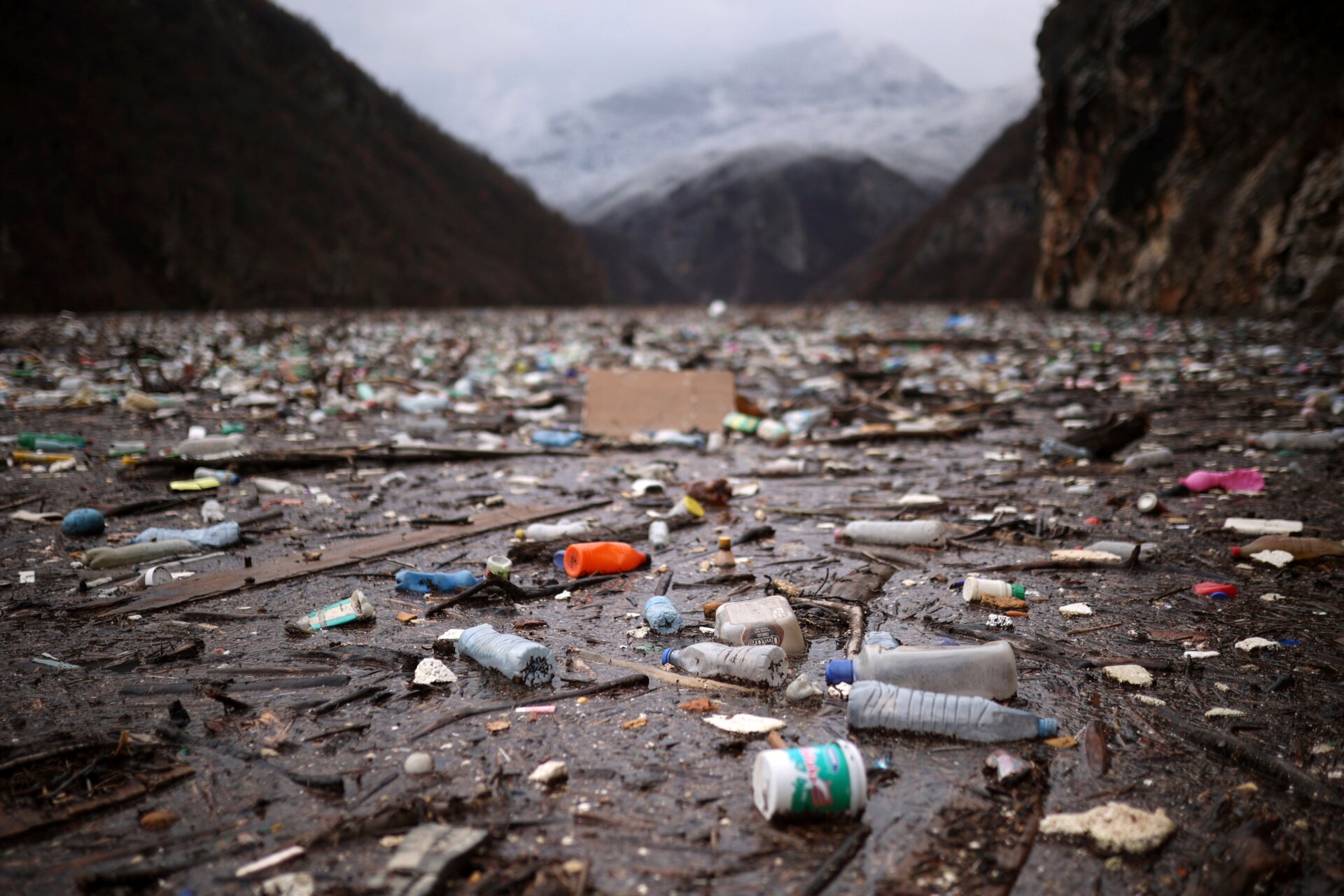 Bottles and other plastic paraphernalia lie in the trash heap.