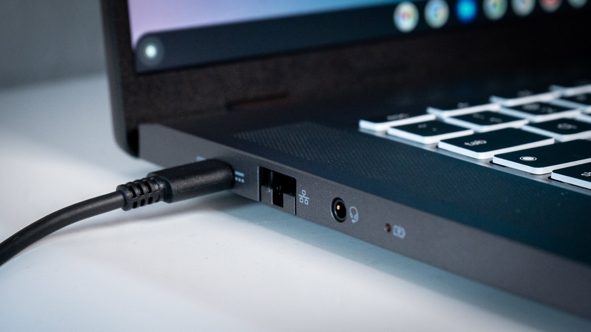 The left side of the Chromebook 516 GE has an ethernet port, a charging port, and a headphone jack. 