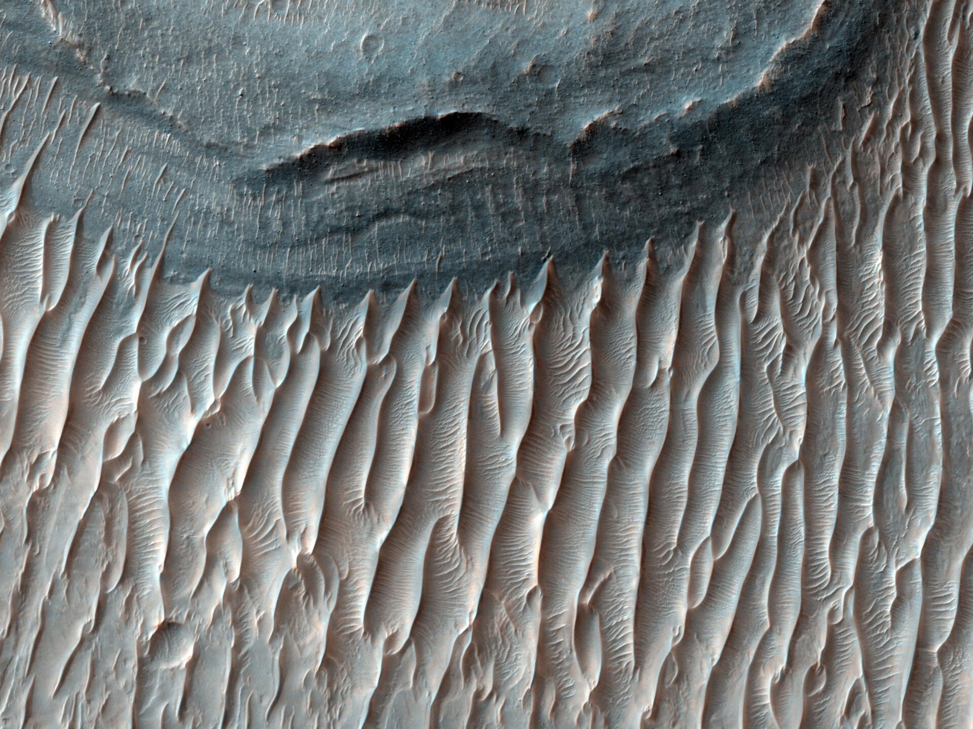 Ius Chasma shows signs of water and wind, which shaped these rivulets.