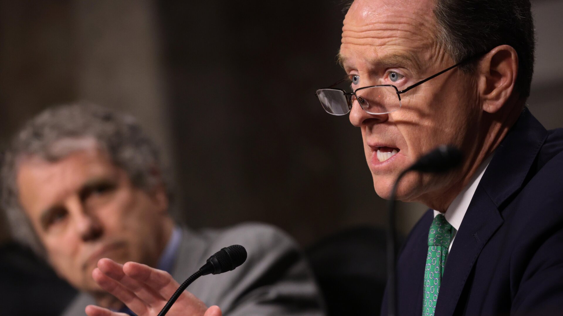 Committee ranking member Sen. Pat Toomey (R-PA) (R) speaks as Chairman Sen. Sherrod Brown (D-OH) (L) listens during a hearing before Senate Banking, Housing, and Urban Affairs Committee at Dirksen Senate Office Building December 14, 2022