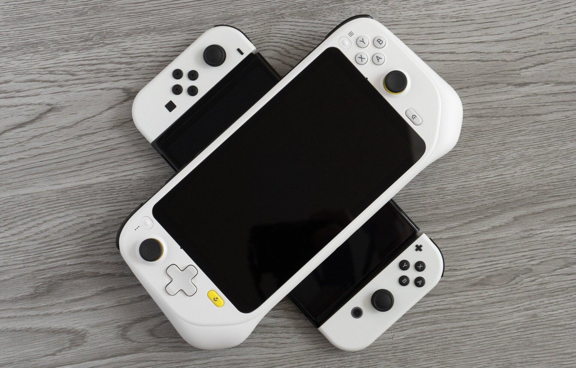 The Logitech G Cloud (top) is just slightly larger than the Nintendo Switch OLED (bottom), but feels more comfortable to hold and play.