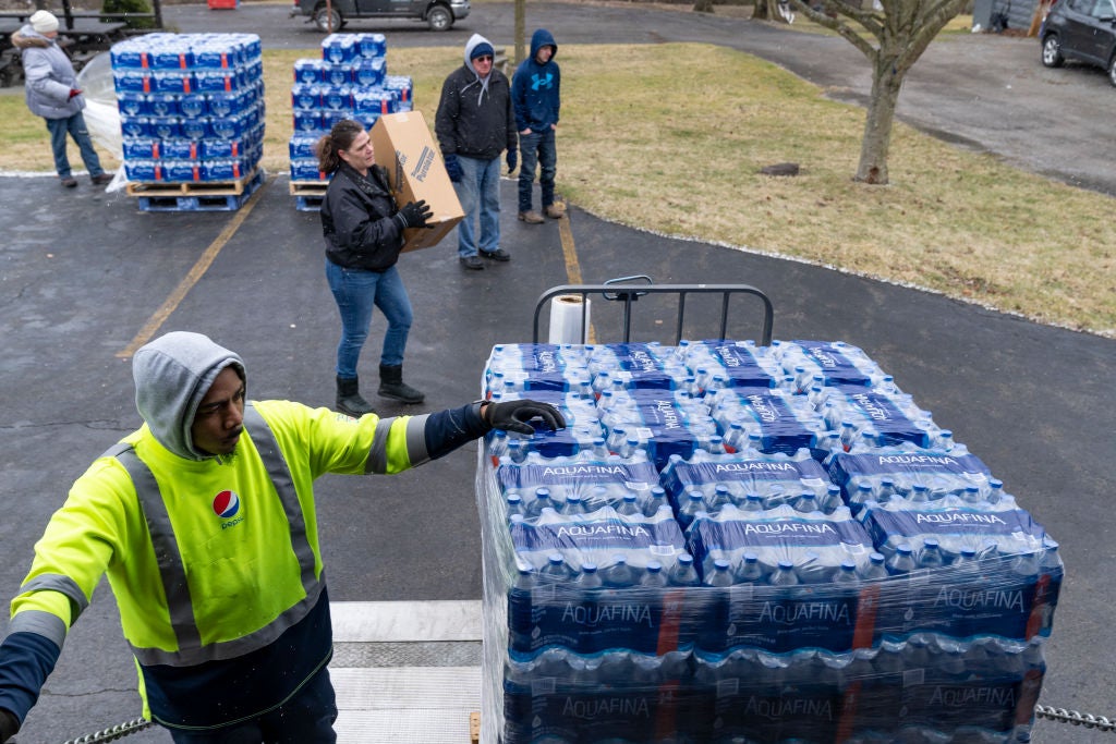 Dean Logan, a worker at Pepsi, delivers cases of water for volunteers to distribute to residents on February 17, 2023 in East Palestine, Ohio. 