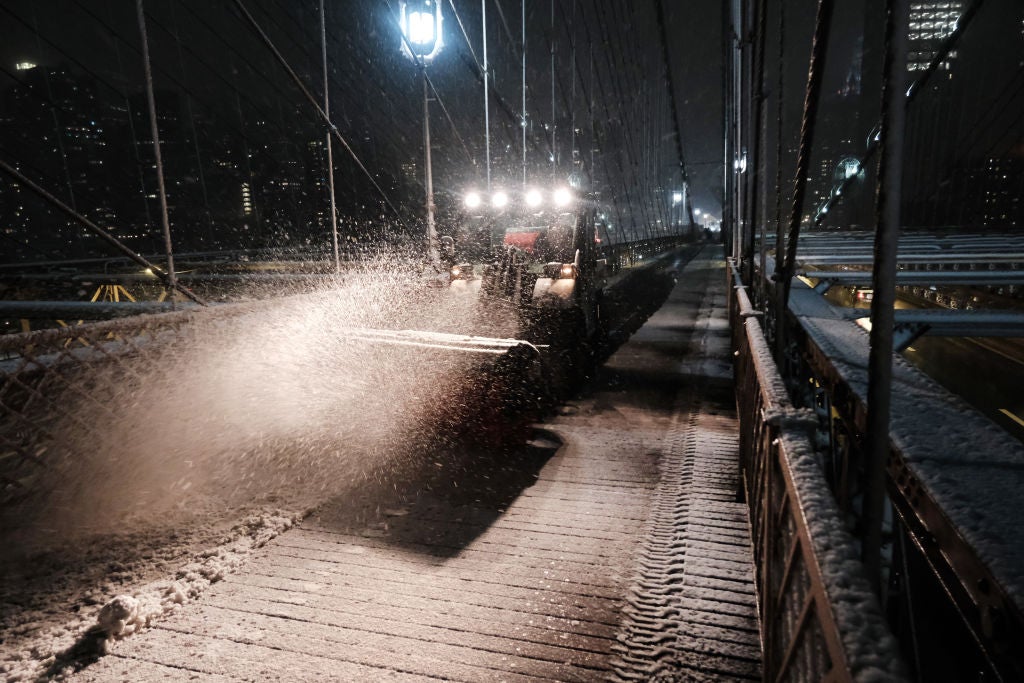 A snow plow clears a path along the Brooklyn Bridge during a storm on February 27, 2023 in New York City.