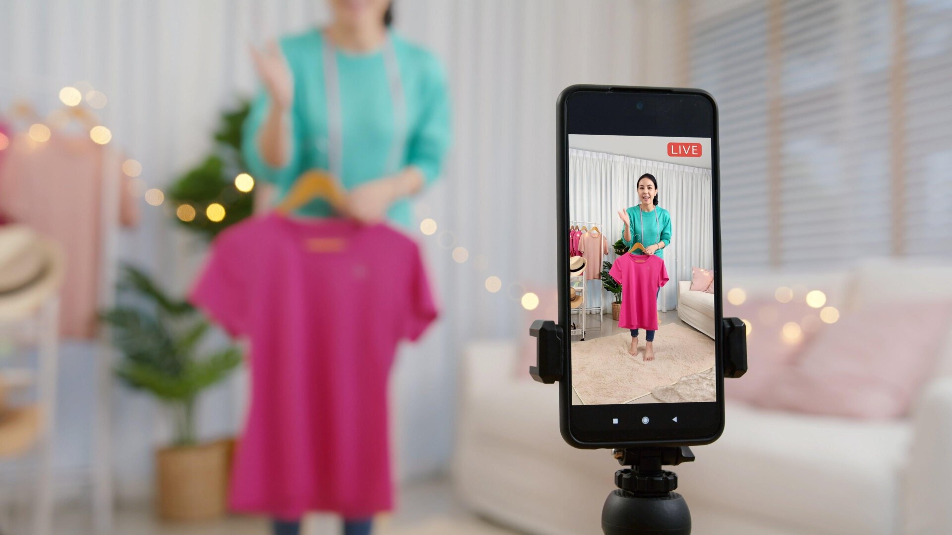 Live Shopping has allowed Instagram creators to tag and link product pages for items in their live broadcasts. Example: imagine a hyperlink floating above the pink shirt in this stock photo, that directs you to a page where you can buy the same shirt. Soon, the feature will be no more.