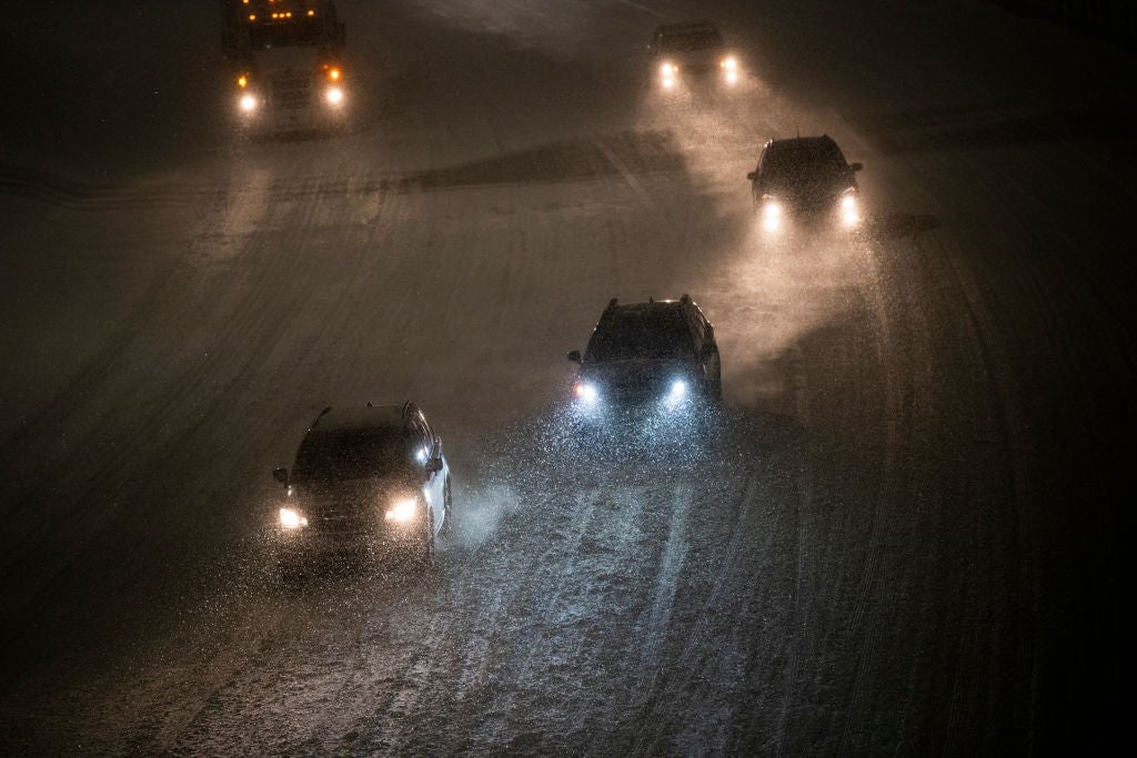 Cars drive through snow along highway 94 on February 23, 2023 in Minneapolis, Minnesota. The winter storm has caused major travel disruption across the country. 
