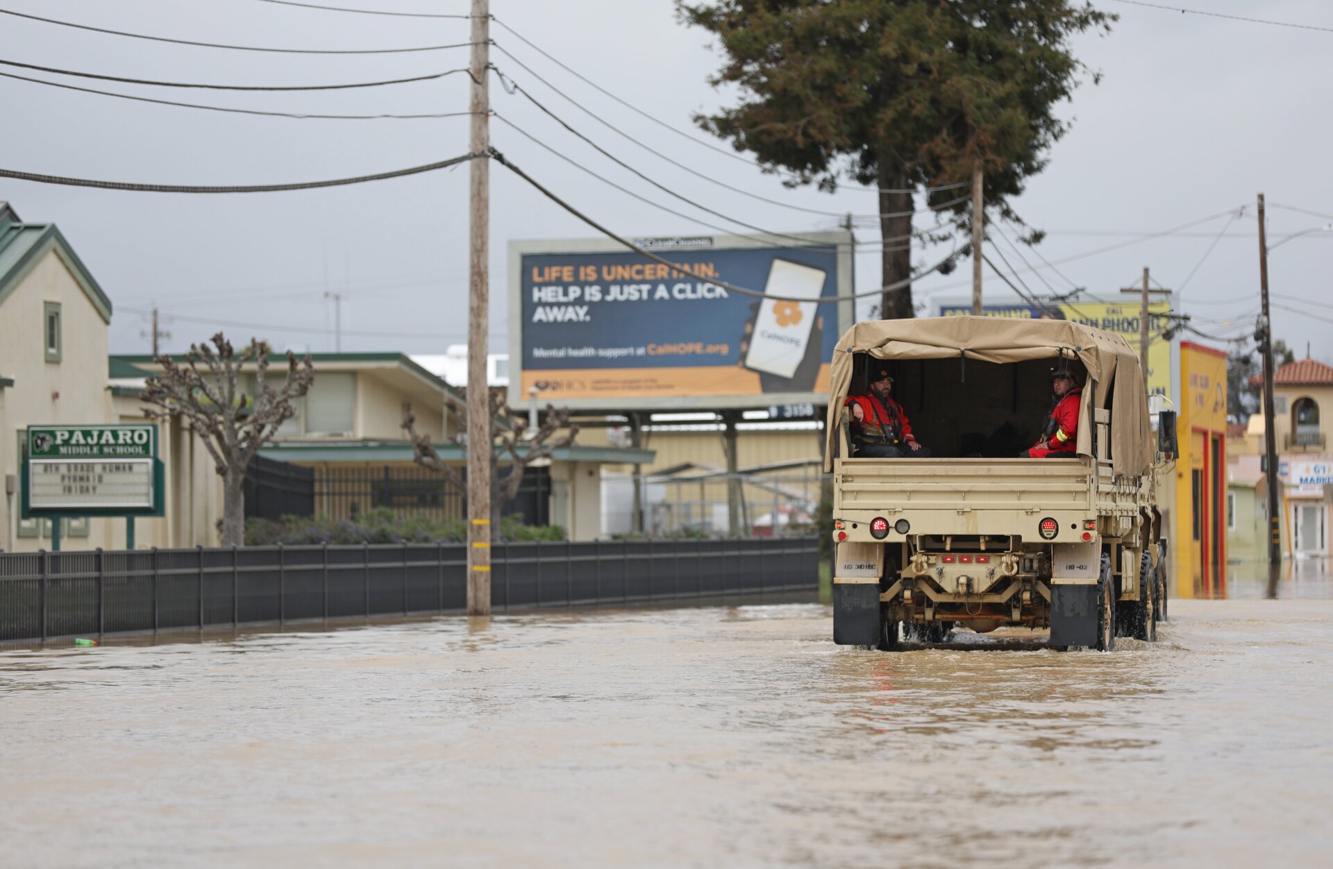 A military vehicle drives through floodwaters in Pajaro on March 14. 
