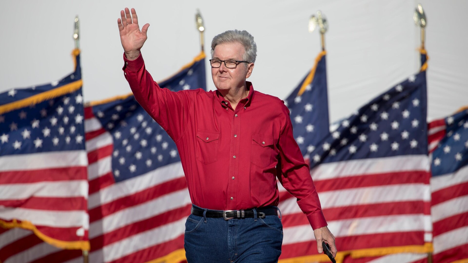 Lt. Gov. Dan Patrick waves to a crowd at a Trump rally.