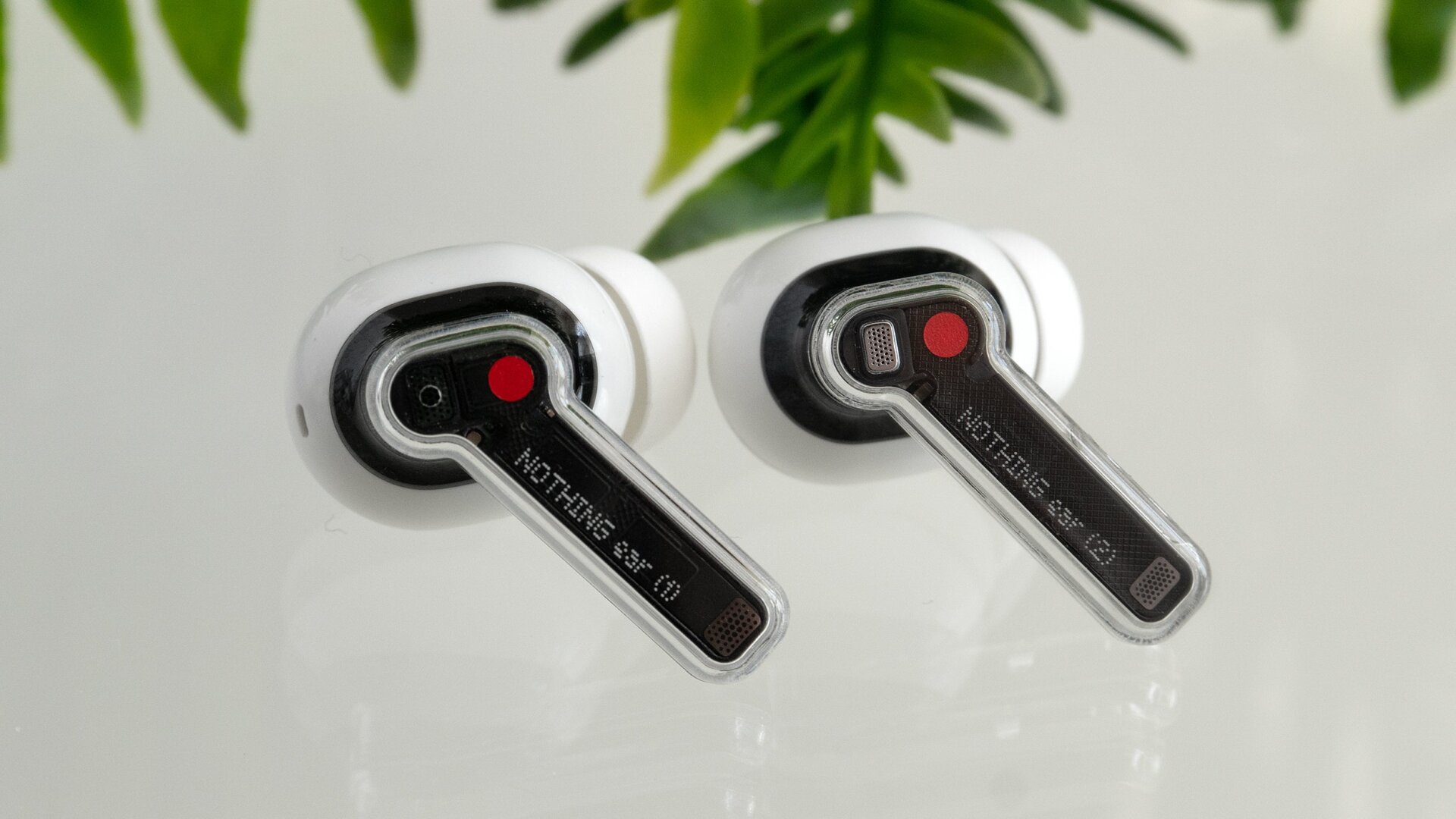 The easiest way to tell a Nothing Ear (1) earbud (left) apart from a Nothing Ear (2) earbud (right) is to simply read the label.