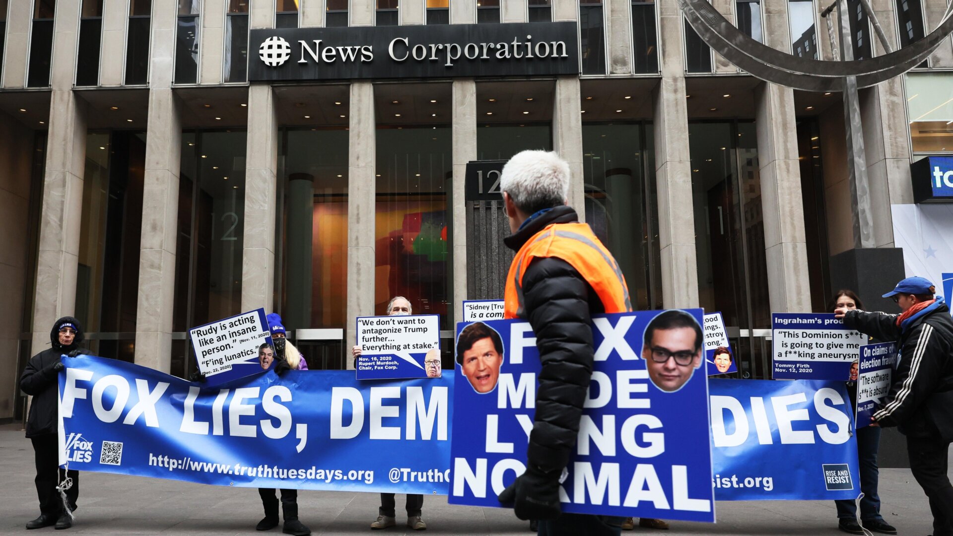 Frequent protesters from Rise and Resist stood in front of the Fox News building in New York City last month with signs citing court documents stemming from the Dominion Voting Systems lawsuit.
