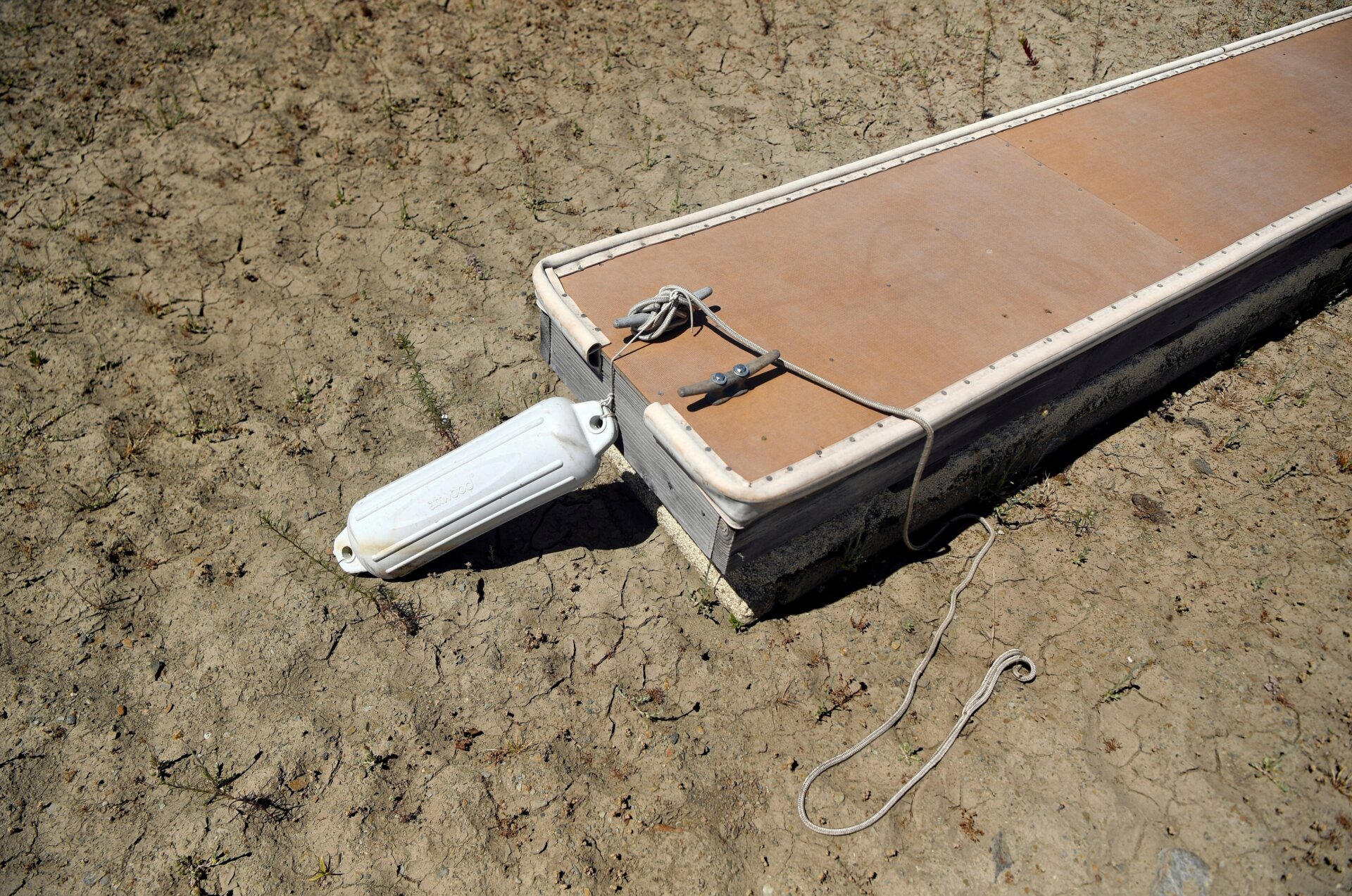 An empty boat dock sits on dry land at the Browns Ravine Cove area of drought-stricken Folsom Lake, in Folsom, California on May 22, 2021. 