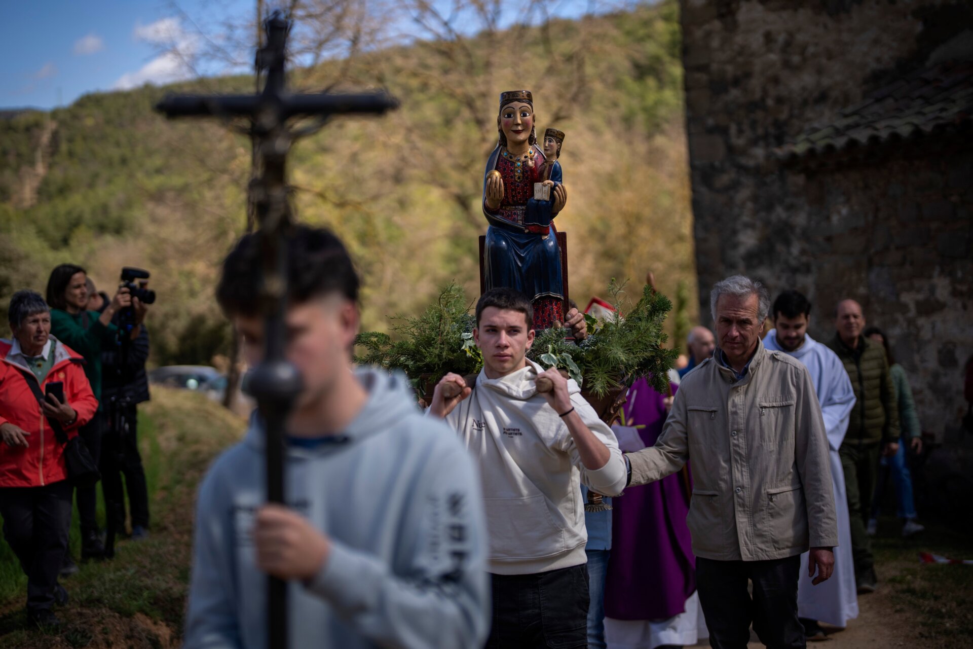 Local residents take part in a procession carrying a statue of the Our Lady of the Torrents, a virgin historically associated with drought, in l’Espunyola, north of Barcelona, Spain, Sunday, March 26, 2023.