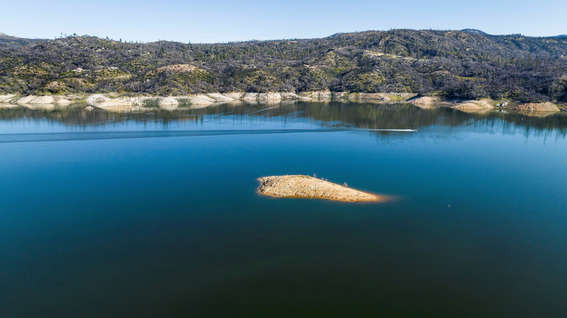 A boat crosses Lake Oroville on Sunday, March 26, 2023, in Butte County, California. 