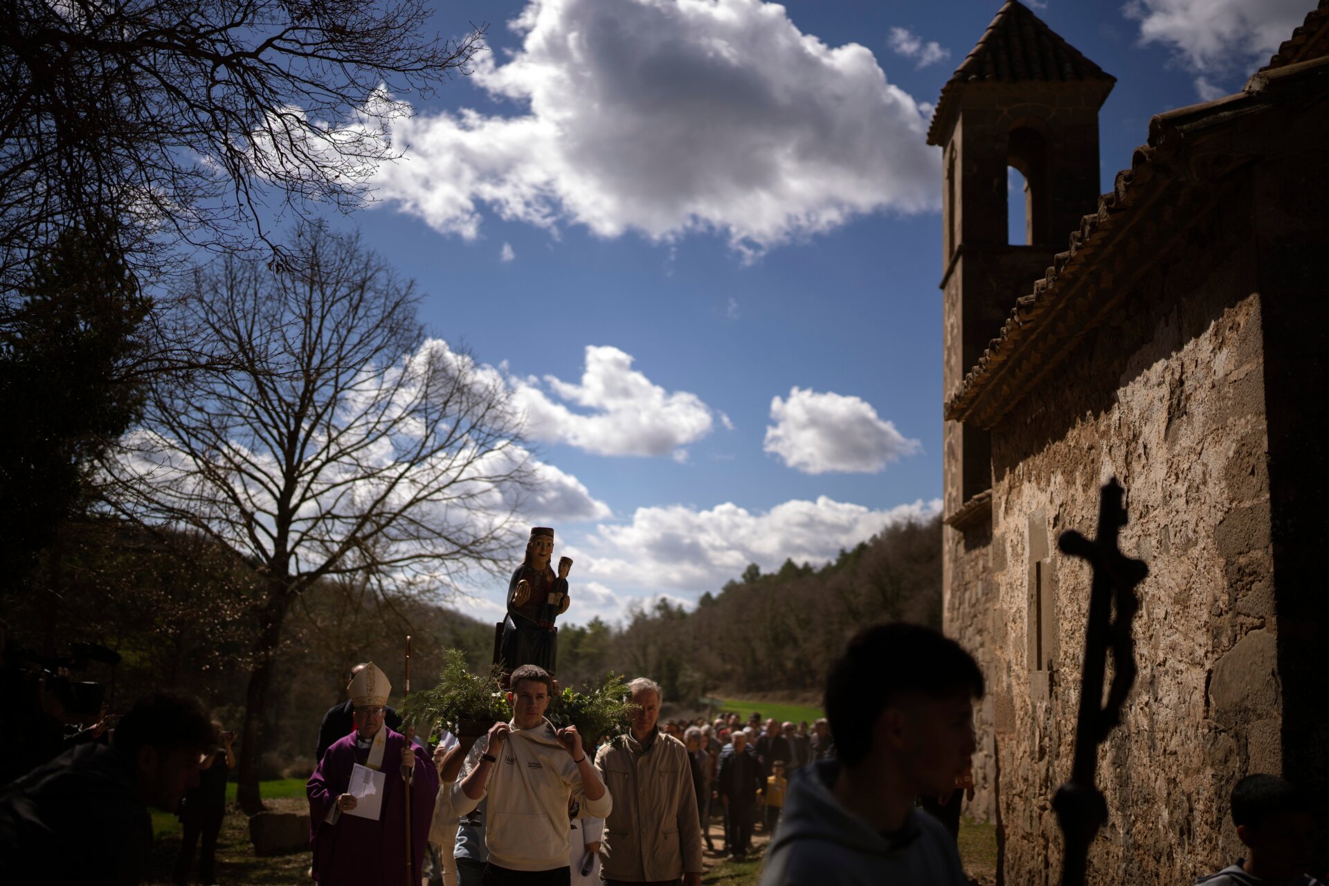 Local residents take part in a procession carrying a statue of the Our Lady of the Torrents, a virgin historically associated with drought, in l’Espunyola, north of Barcelona, Spain, Sunday, March 26, 2023.