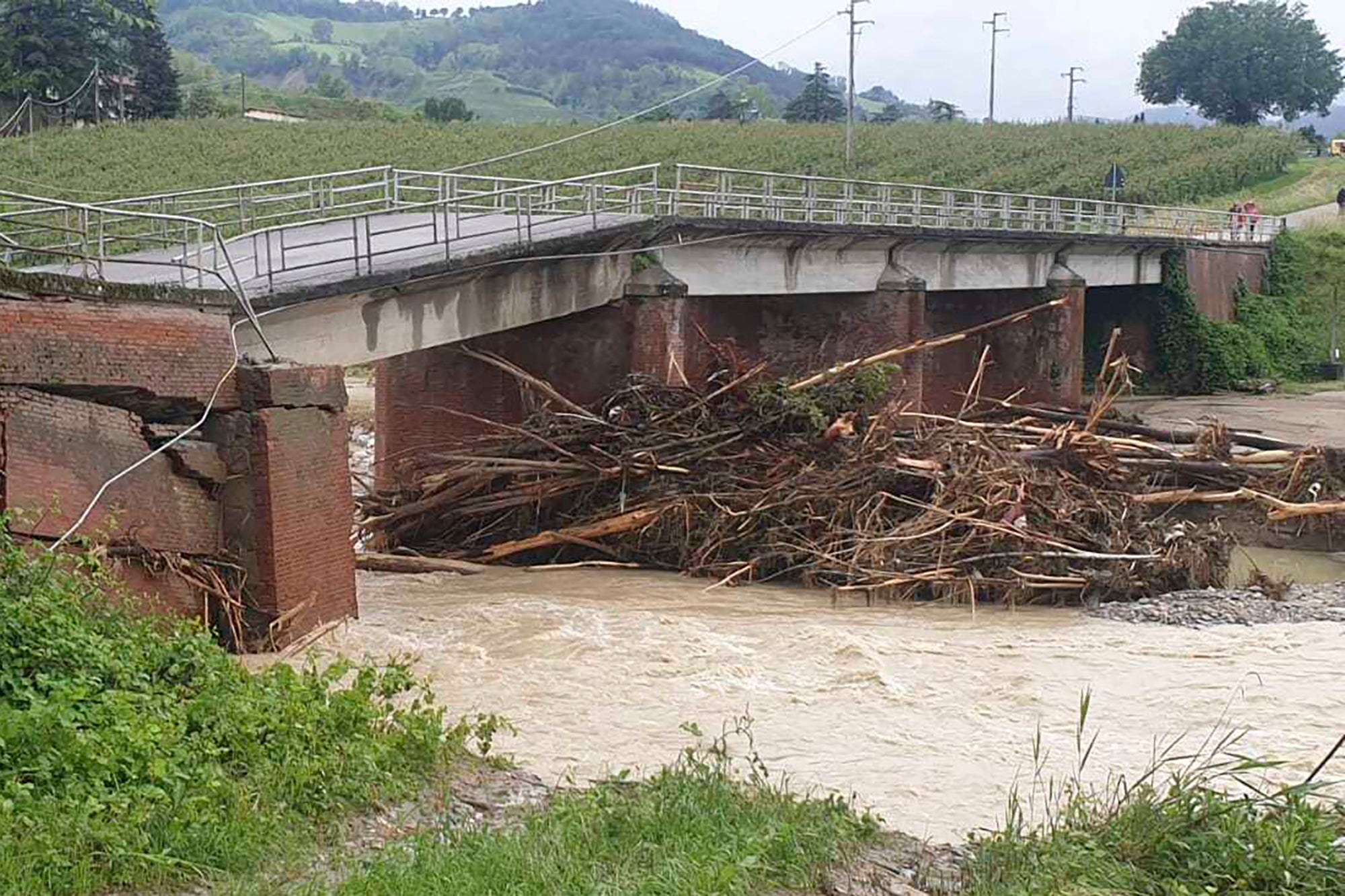Rushing waters, landslides, and debris have left roads left washed out and impassable throughout the region. Here, a bridge between Dovadola and Castrocaro Terme has been heavily damaged by high waters. 