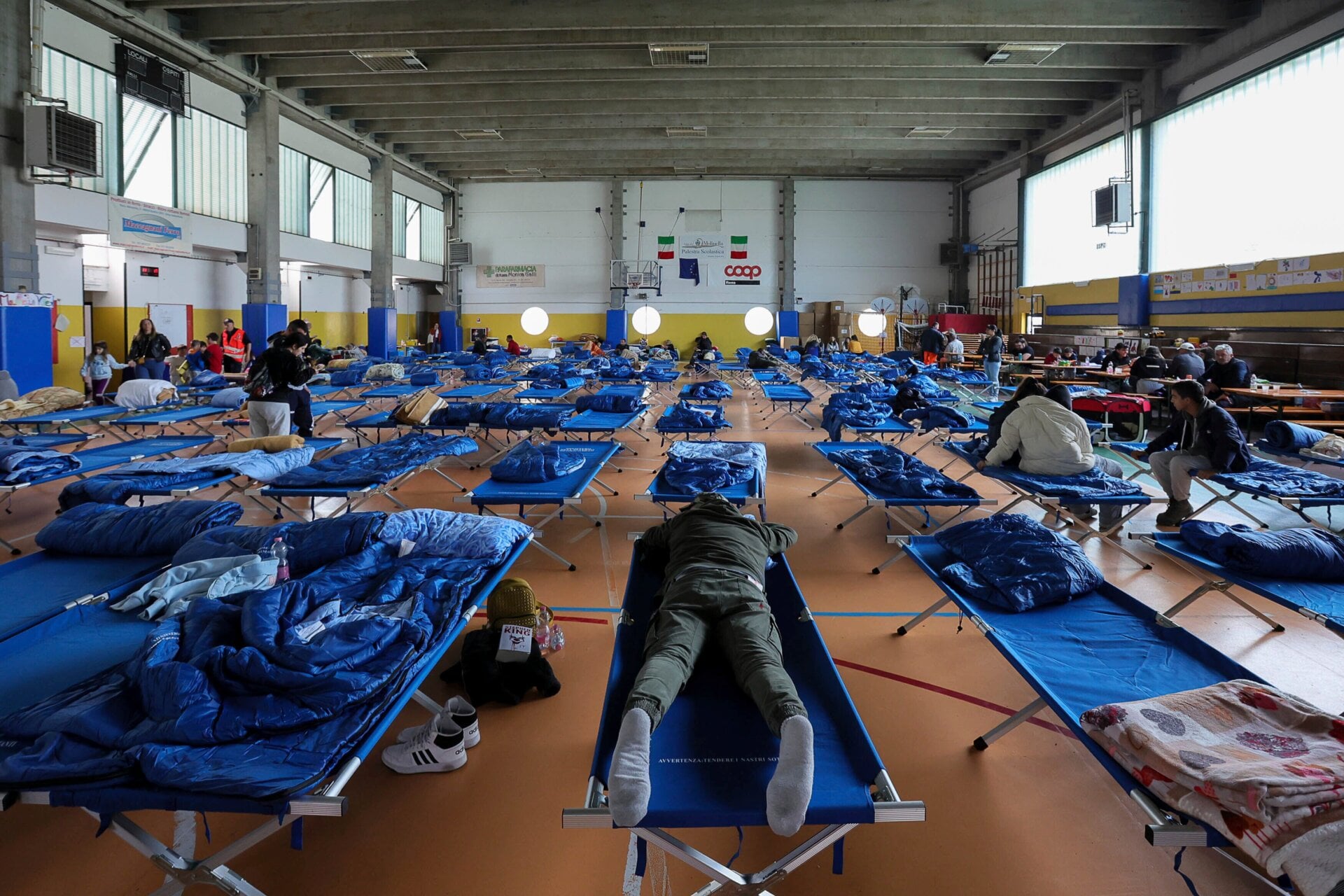 Evacuees rest on cots in an emergency shelter inside a gymnasium in Bologna, Italy on May 18. 