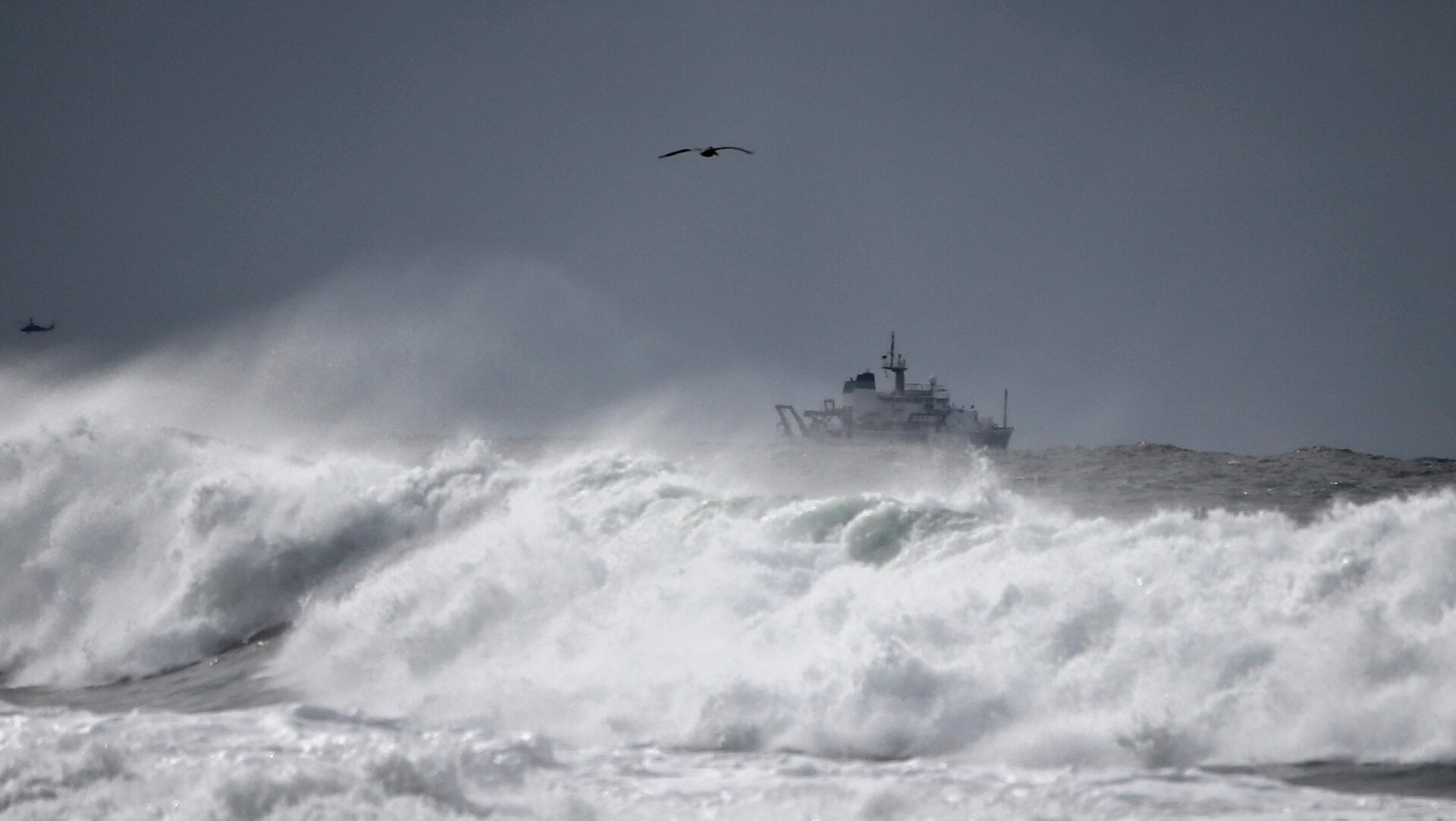 A Coast Guard ship navigates through a rough ocean near California in January 2016. El Niño storms produced heavy rain, large waves, and extensive damage.