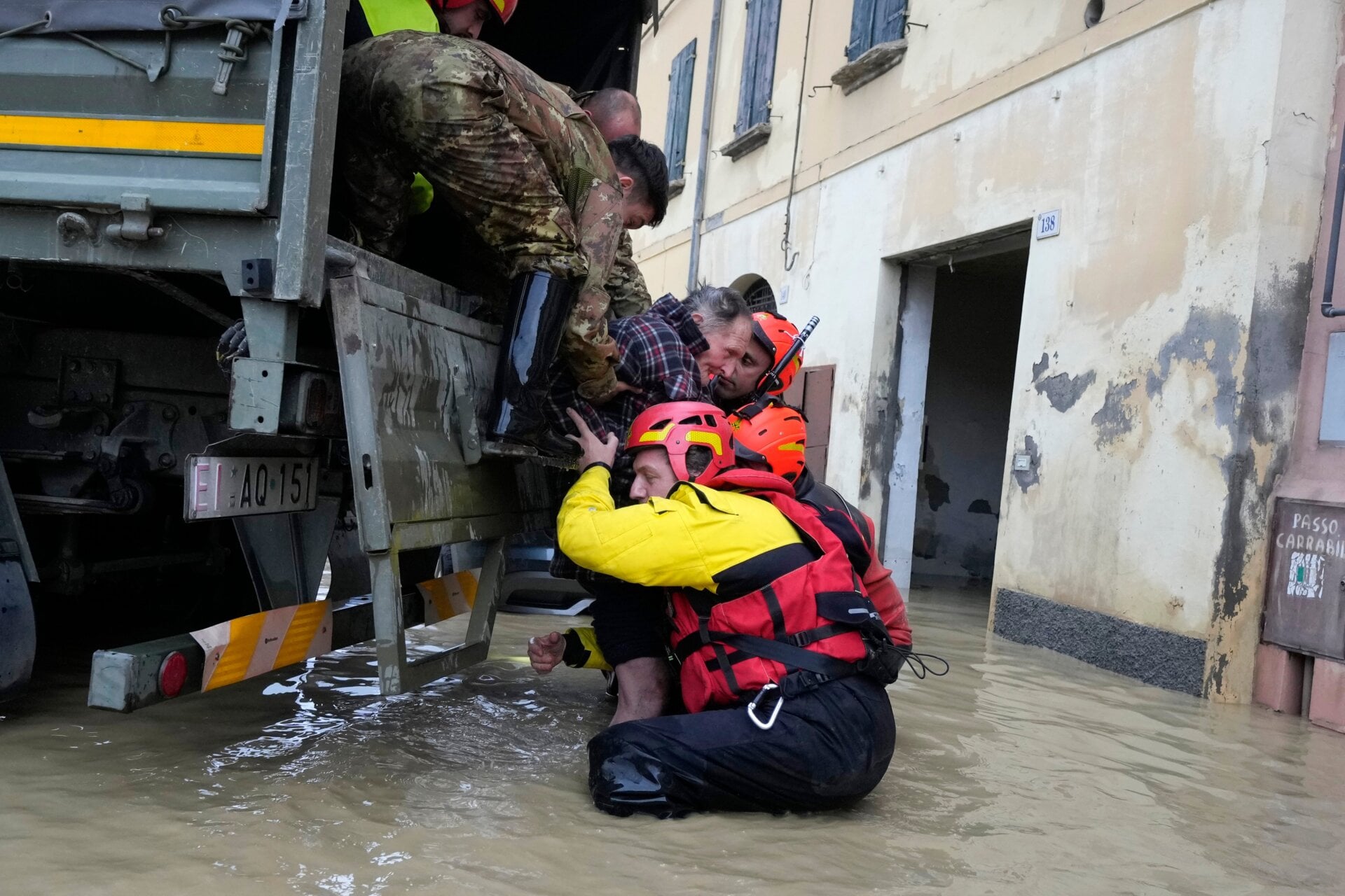 Firefighters pull an elderly man from floodwaters in the village of Castel Bolognese, Italy on May 17. At least 14 people were killed in the disaster. 