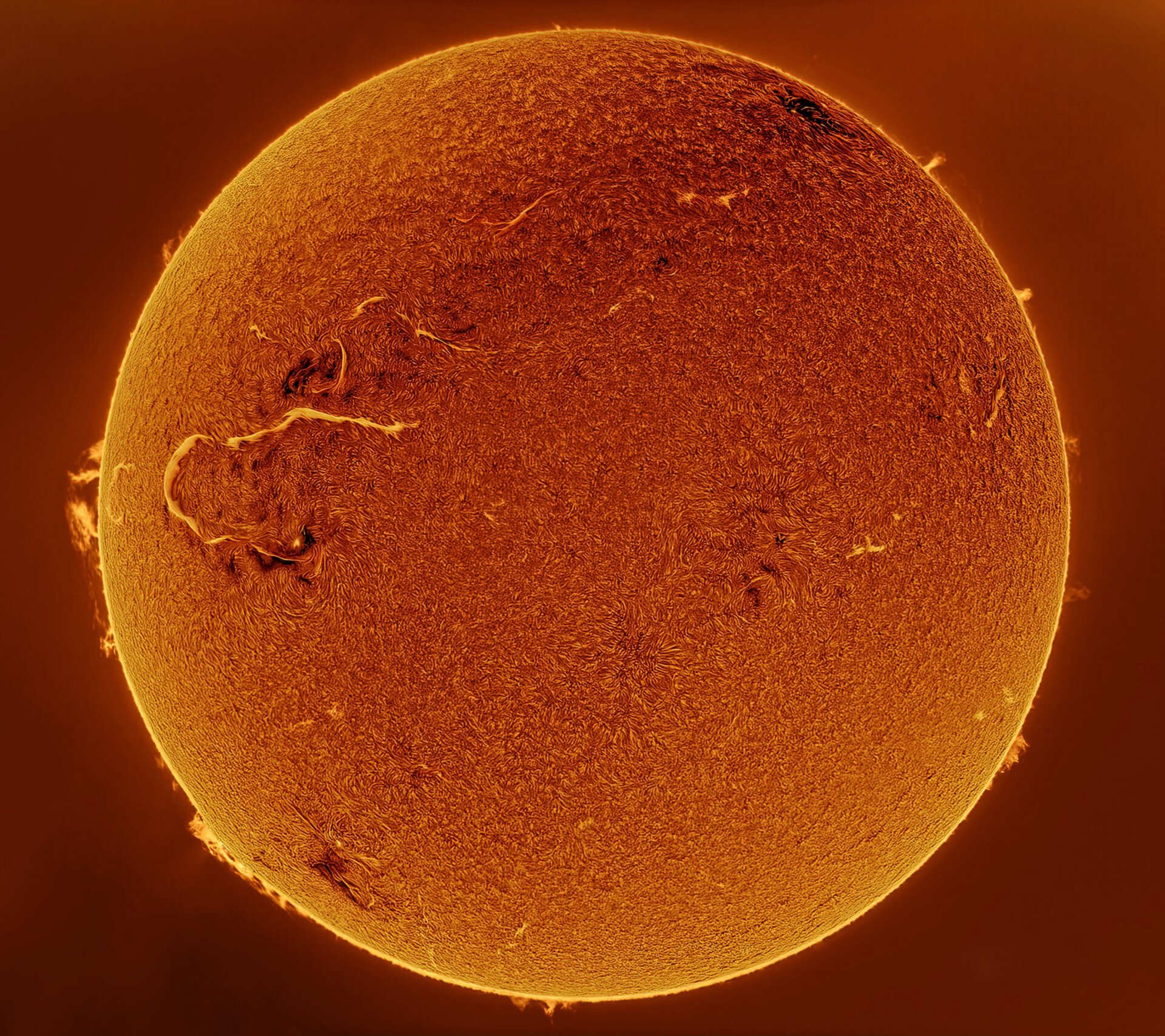 The Sun, with a large solar flare on its left side.
