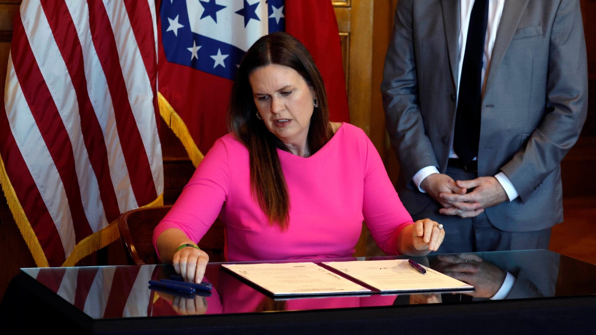 Arkansas governor Sarah Huckabee Sanders signing SB 396 into law in April.