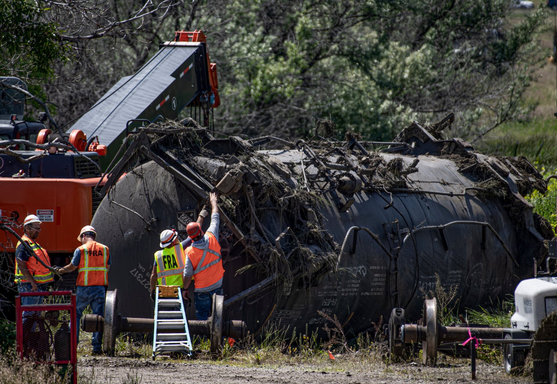 Crews work at the site of a railroad bridge collapse on the Yellowstone River near Reed Point on Sunday, June 25, 2023, in Columbus, Montana.