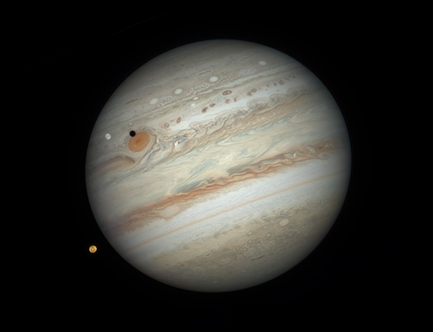 Jupiter, with two of its moons in the foreground.
