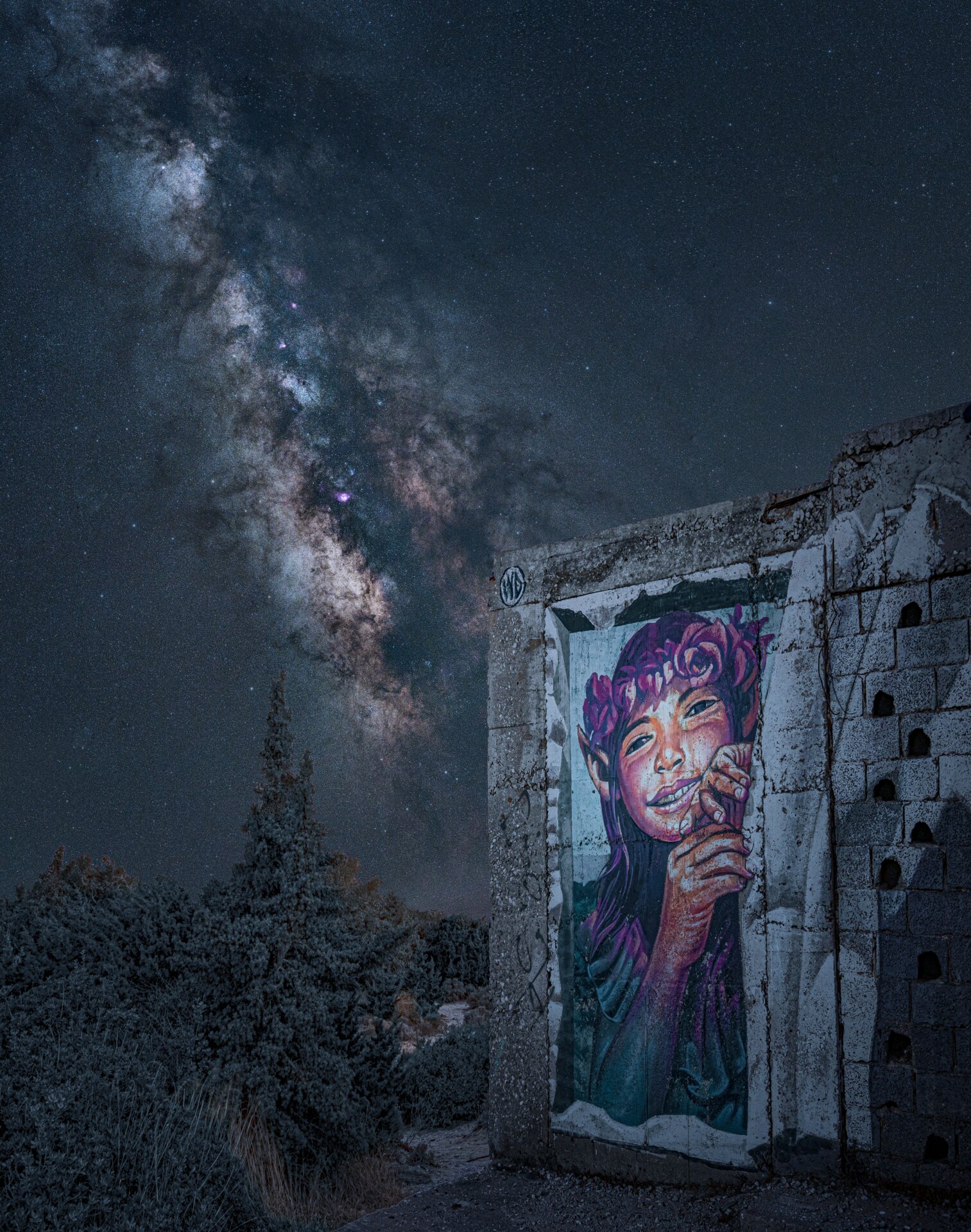 The Milky Way looms behind a graffito.